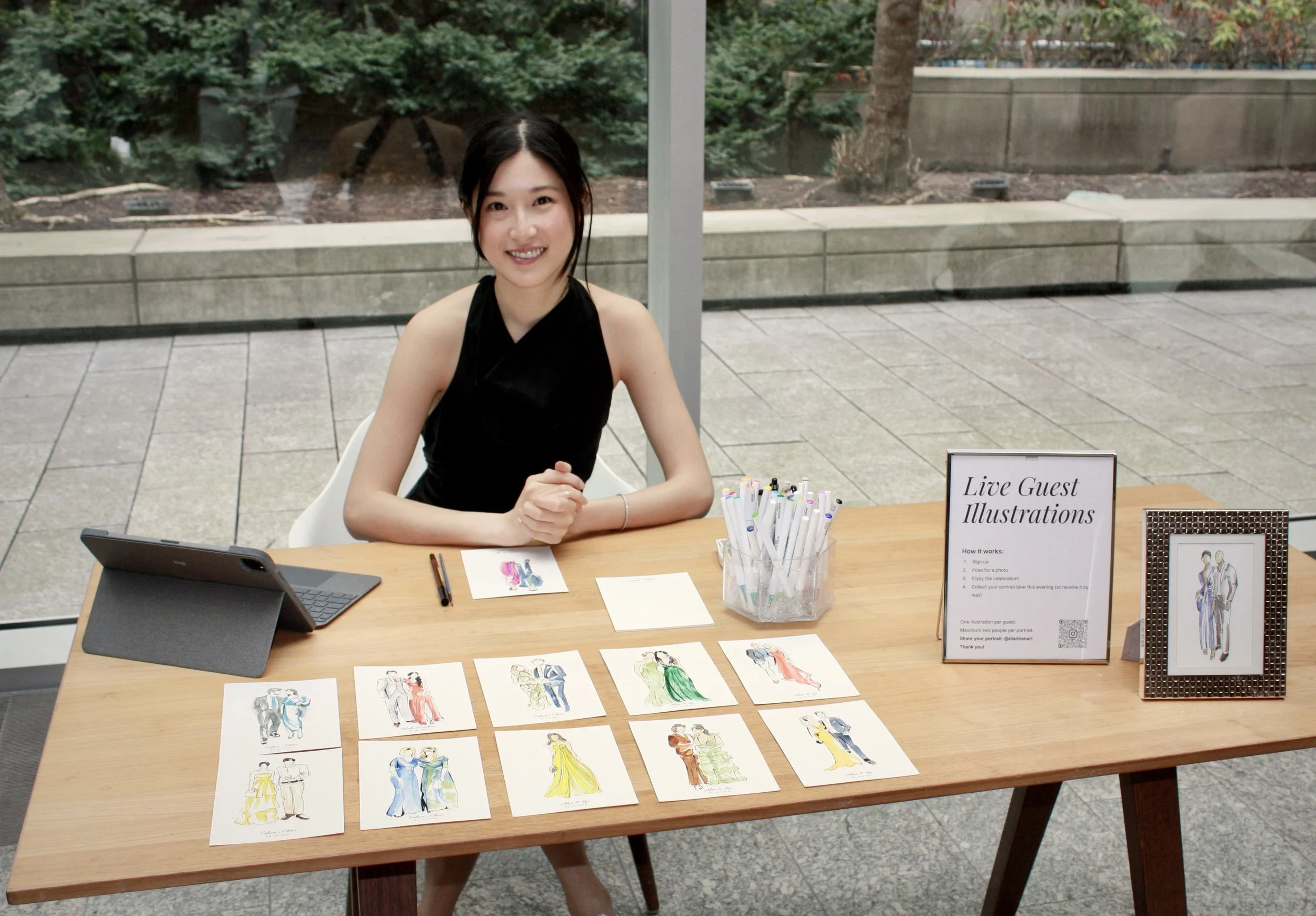 live wedding guest portrait artist station displaying watercolor illustrations at event in Toronto