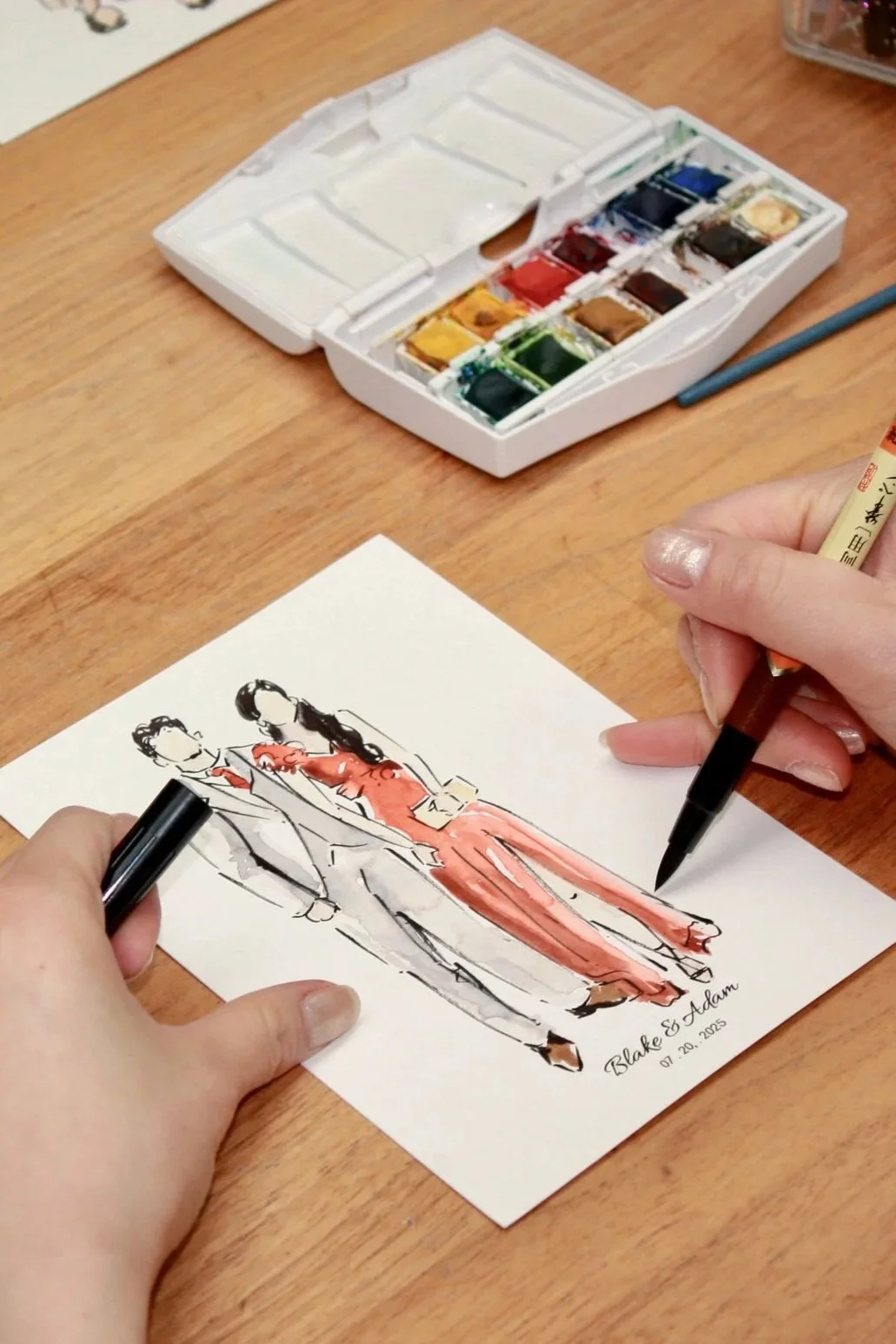 artist painting wedding guests with watercolour and ink brush japanese