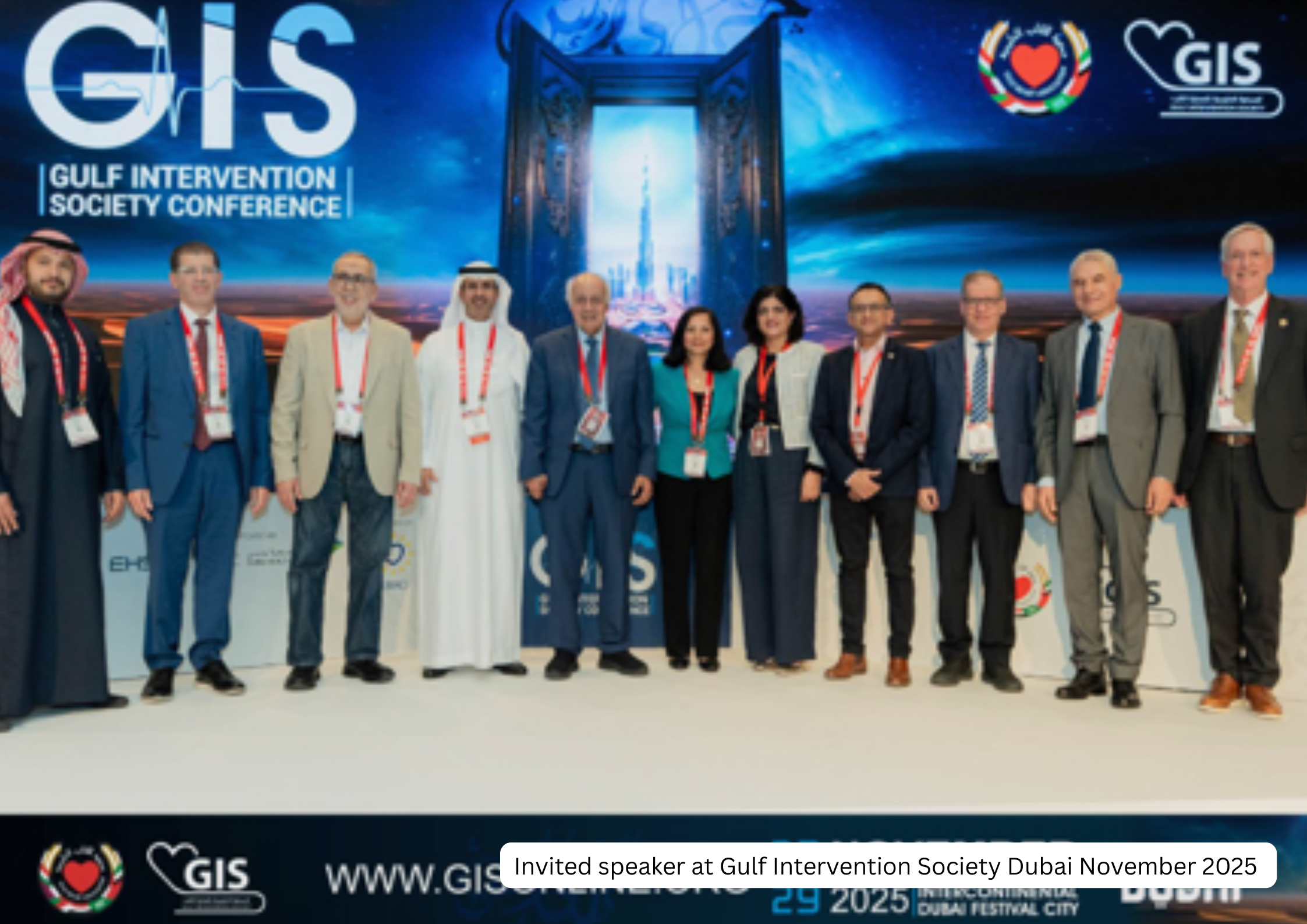 A group of diverse professionals standing together on stage at the Gulf Intervention Society Conference in Dubai, November 2025, with a backdrop displaying the conference logo and a futuristic cityscape.