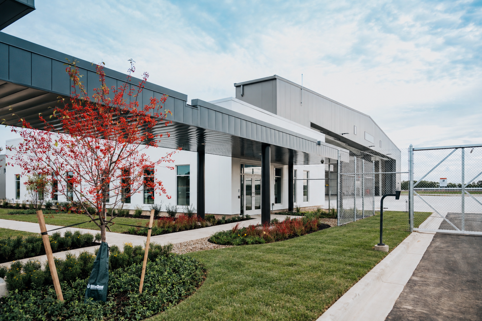 Entrance to the Stryker Sky High office and administration building with a covered walkway and landscaping