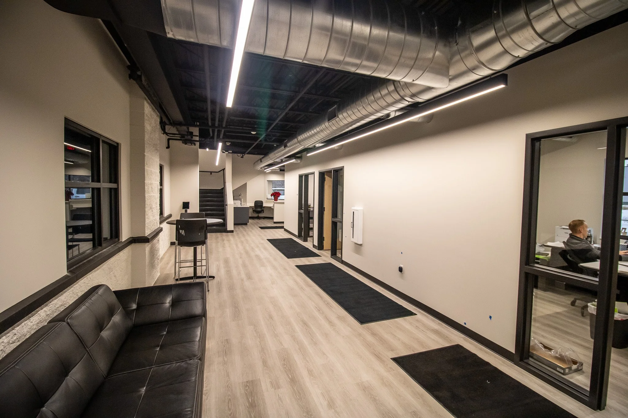 AFX first-floor renovation featuring new offices, reception area, and open office space.