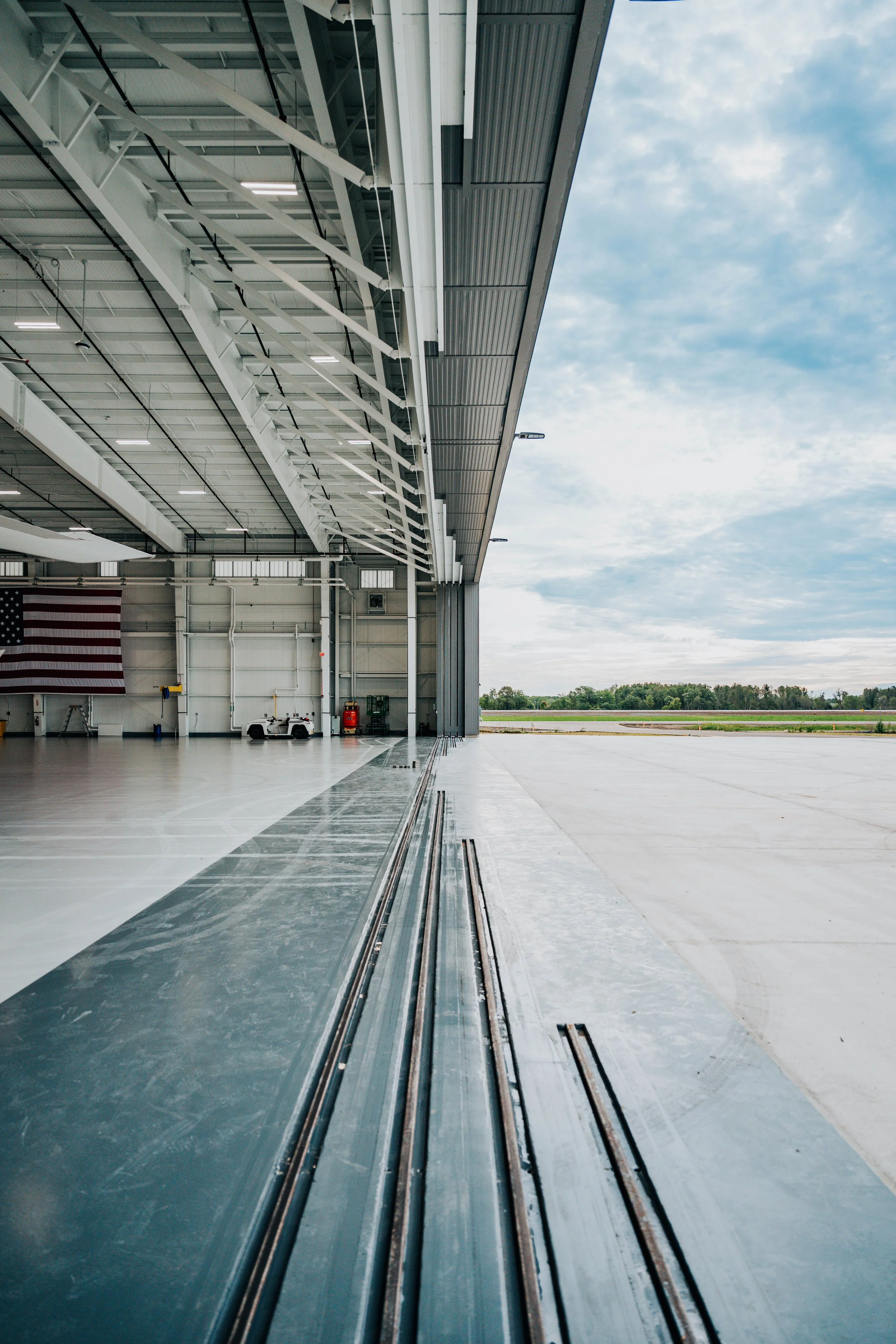 View from inside the Stryker Sky High hangar in Portage, MI, showing the open 120-foot-wide hangar door and PEMB steel framing