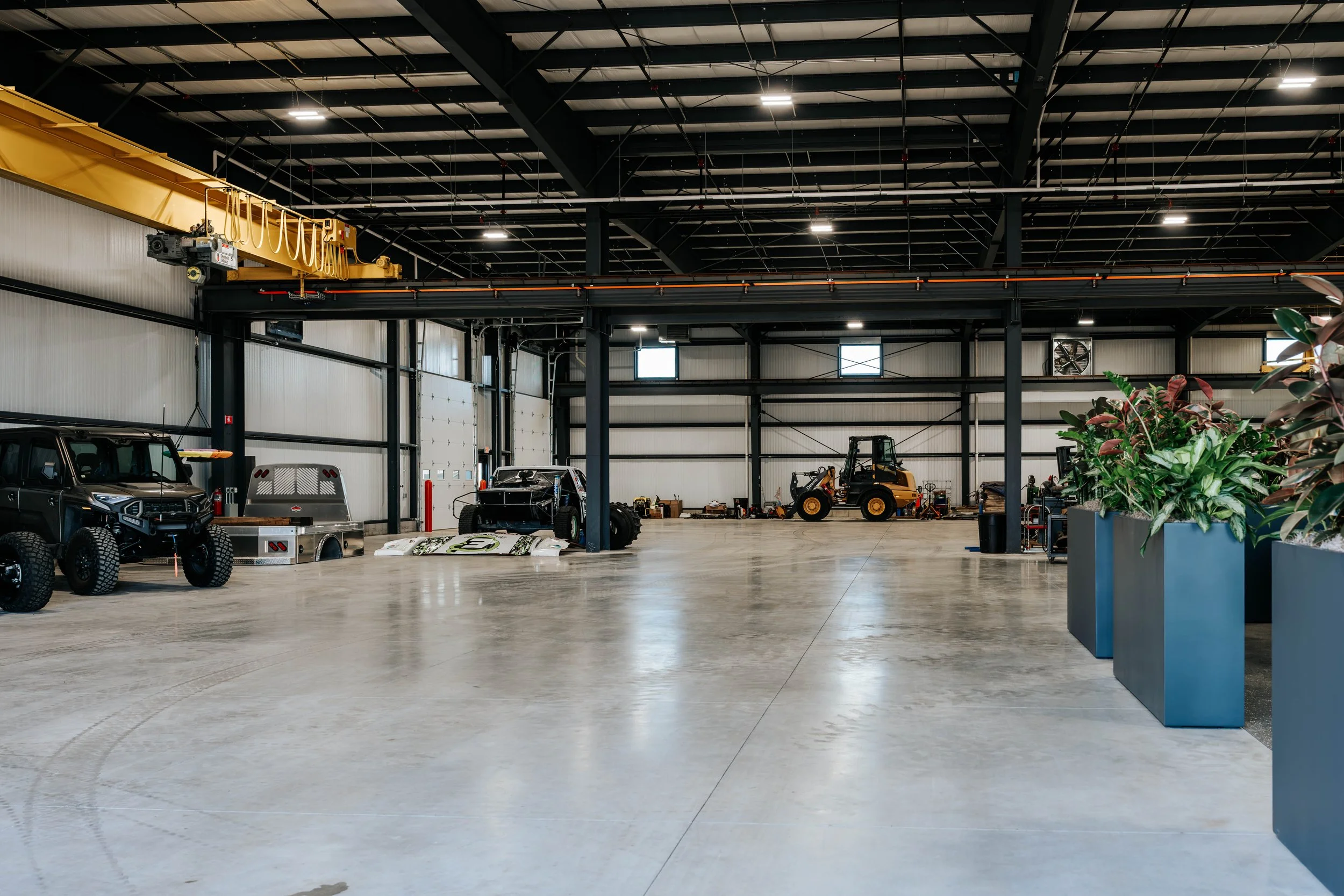 Open shop floor in the PDM Properties building, showing the exposed steel framing, high ceilings and a bridge crane.