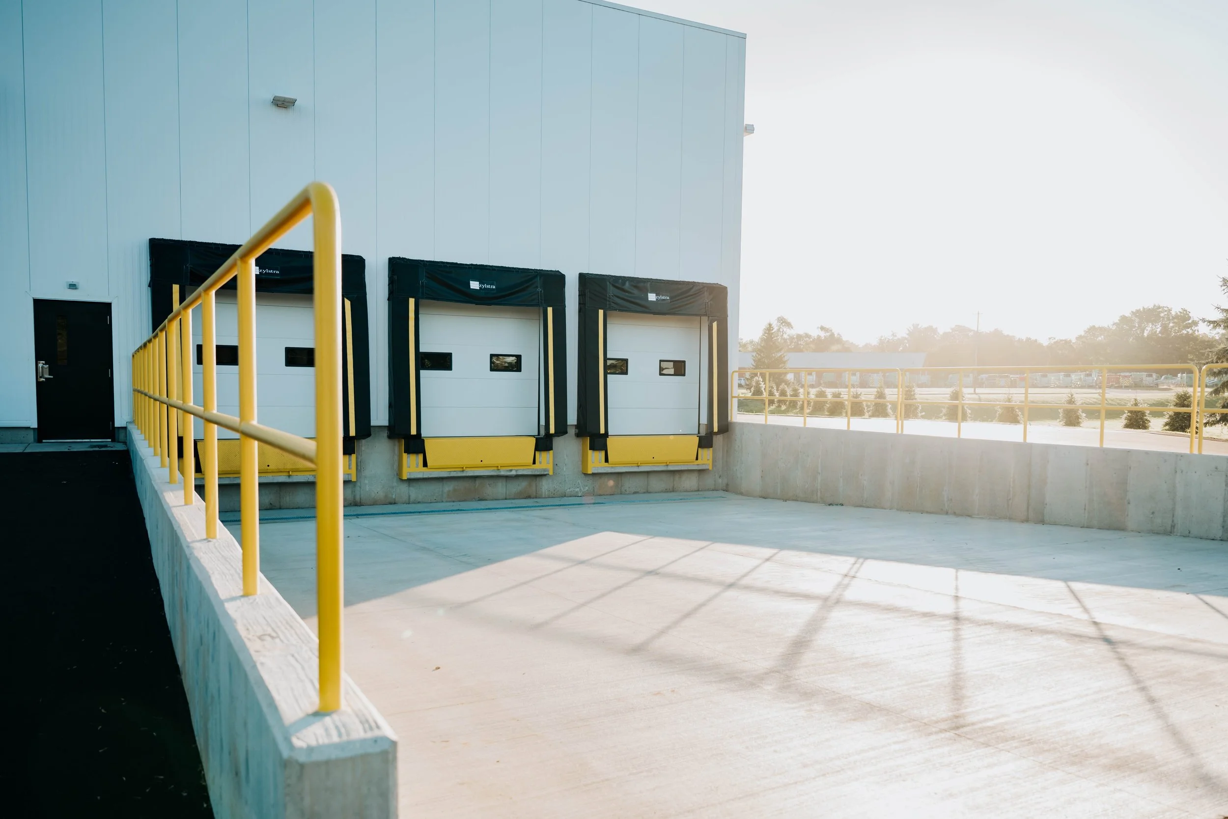 Three loading dock doors with dock seals and levelers along the truckwell at the Weller Auto building addition