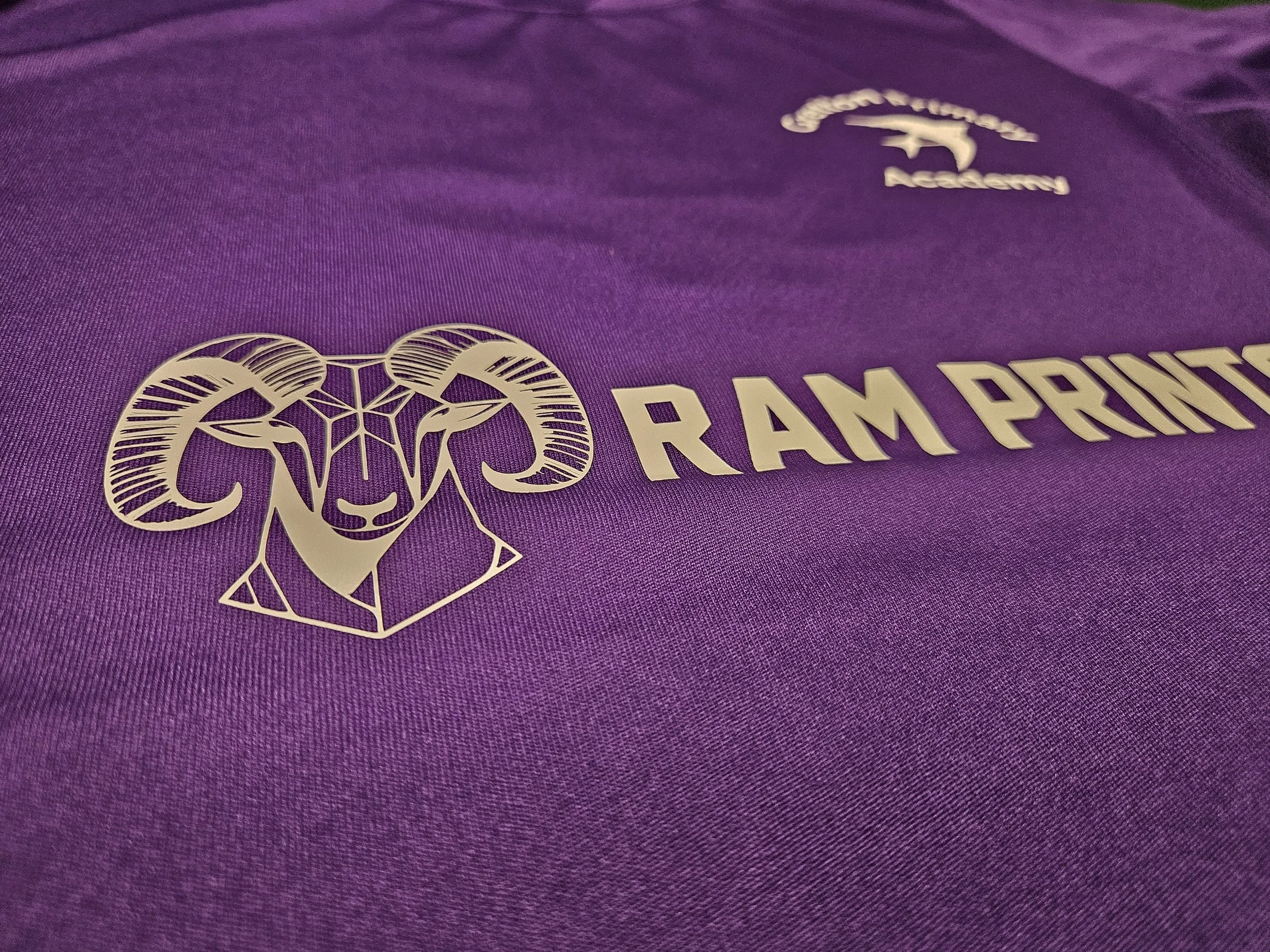 Close-up of purple fabric with a logo featuring a ram's head and the words "RAMPOWER" at the bottom.
