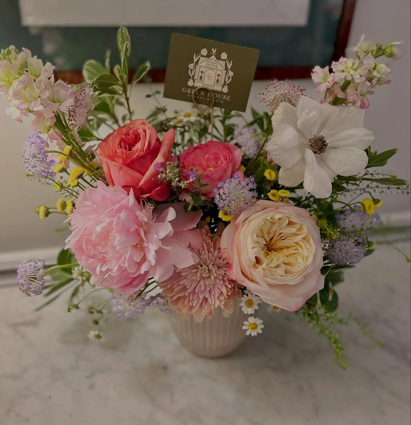A bright retirement arrangement to brighten yet another dreary, rainy day. This is the first time I have used one of the roses from my new bushes in an arrangement. The bushes are still establishing and blooms are small and more infrequent, however t