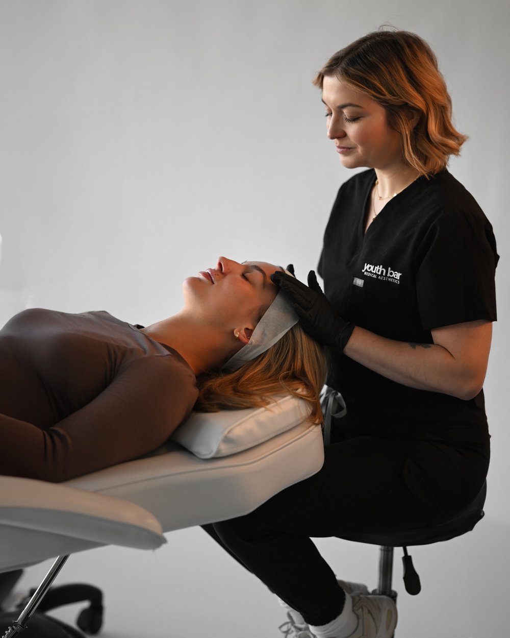 Stephanie assessing a client before a Botox treatment at Youth Bar in Halifax