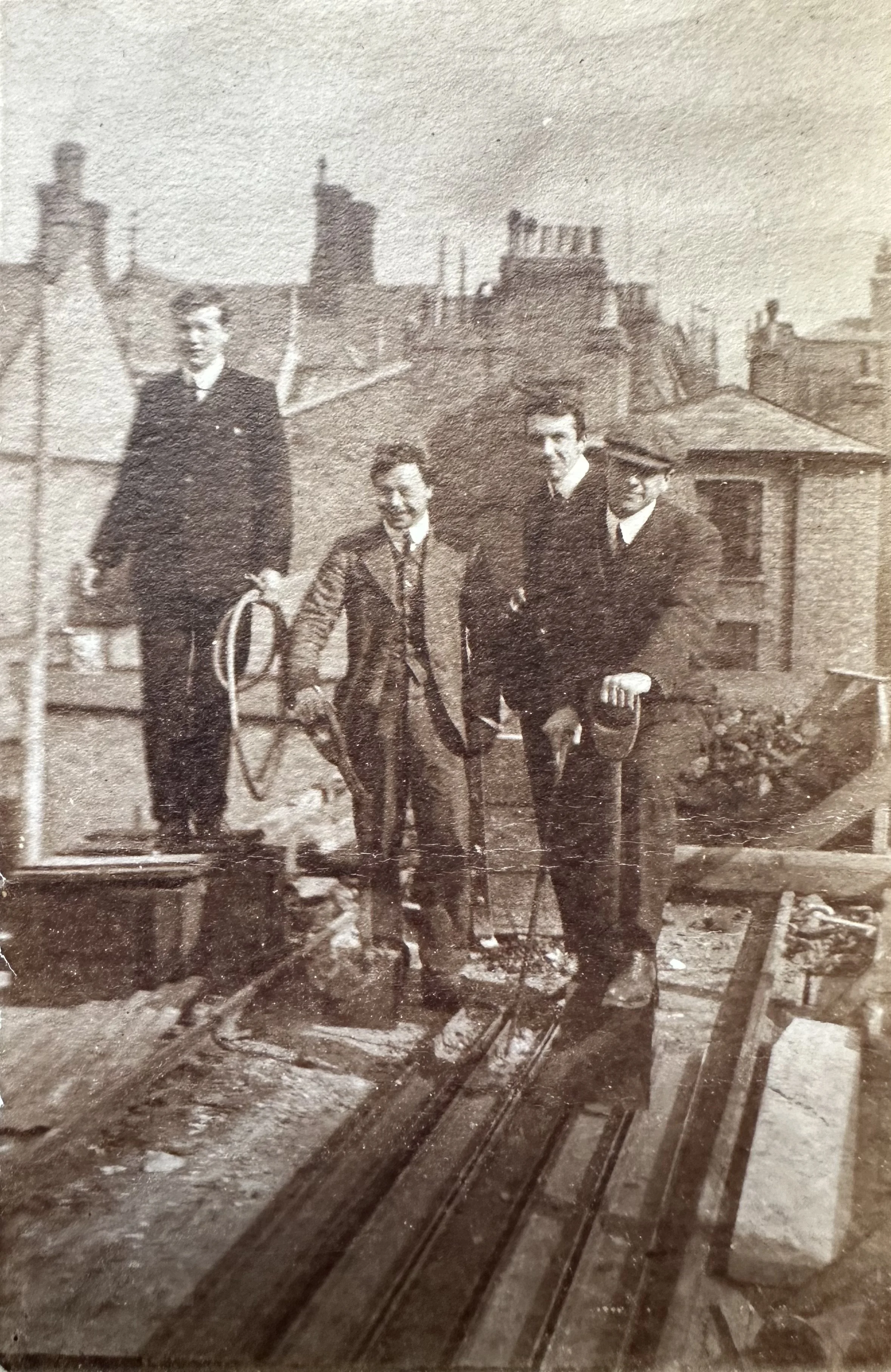 Four men on a rooftop during building works (Cambridge, probable) c.1890