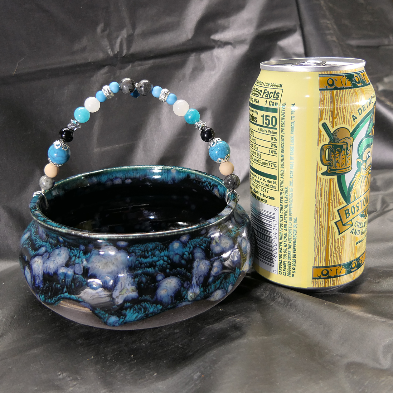 blk teal cauldron on alter with can.png