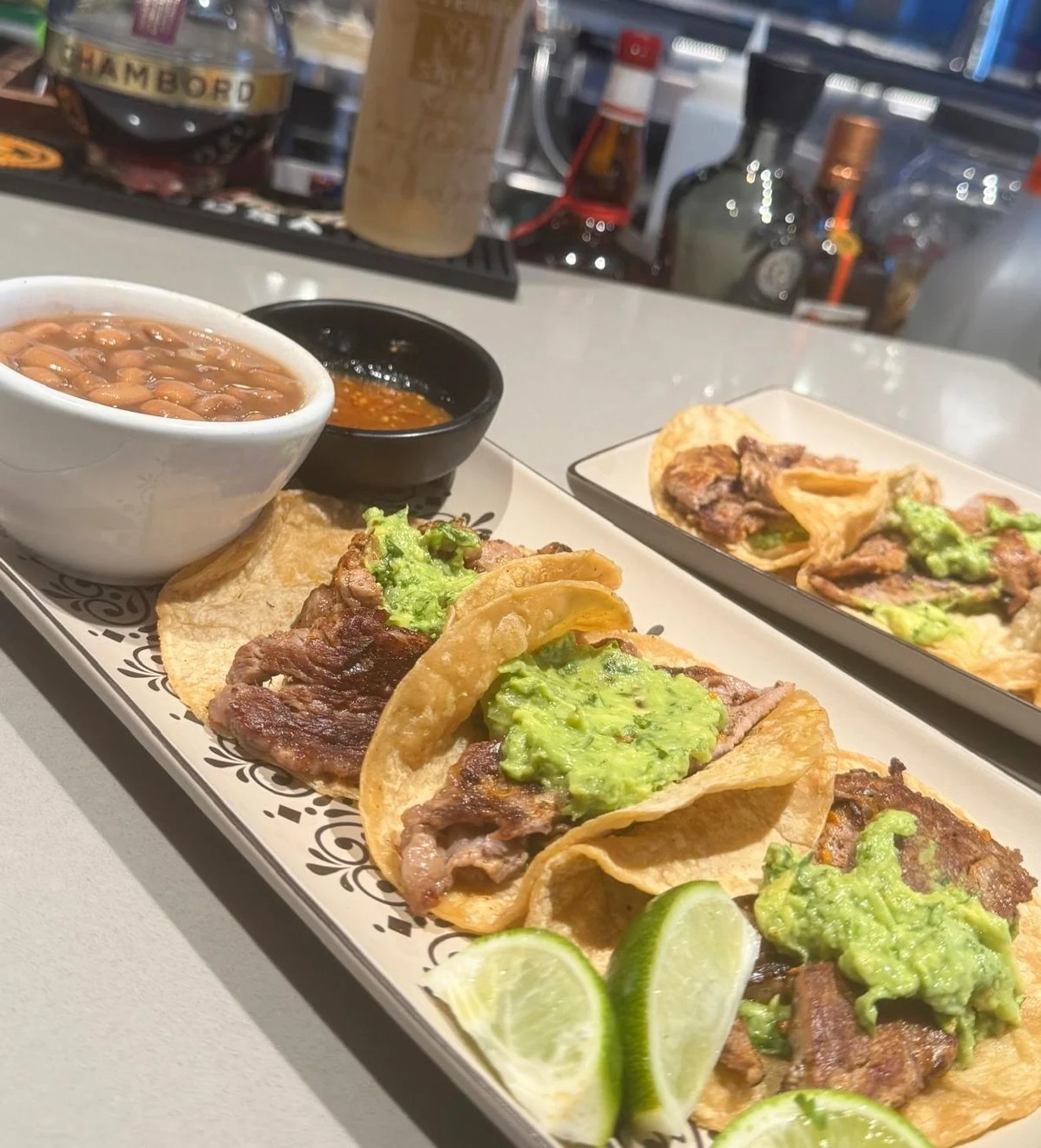 Homemade, authentic ribeye tacos: tender, juicy, and dangerously irresistible. Roy&rsquo;s newest creation! 3 ribeye tacos in a corn tortilla topped with guacamole. With a side of our special hot salsa, lime, and charro beans!