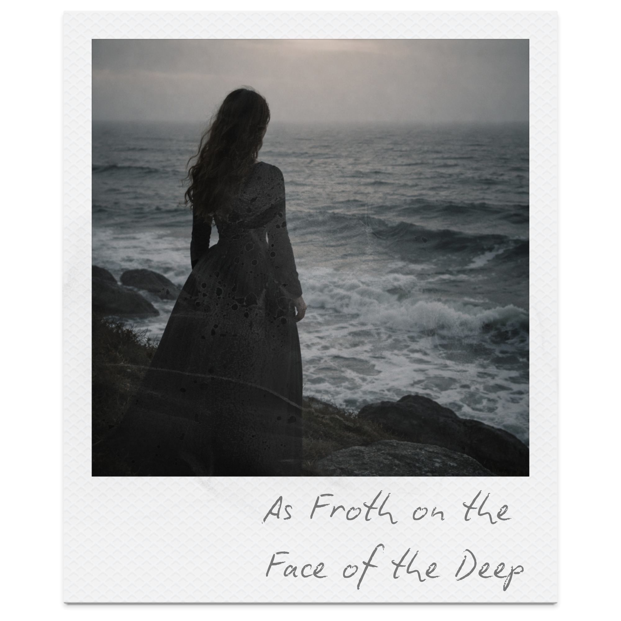 A woman standing on a rocky shoreline looking at the ocean during dusk, with waves crashing onto the rocks, and the sky overcast.