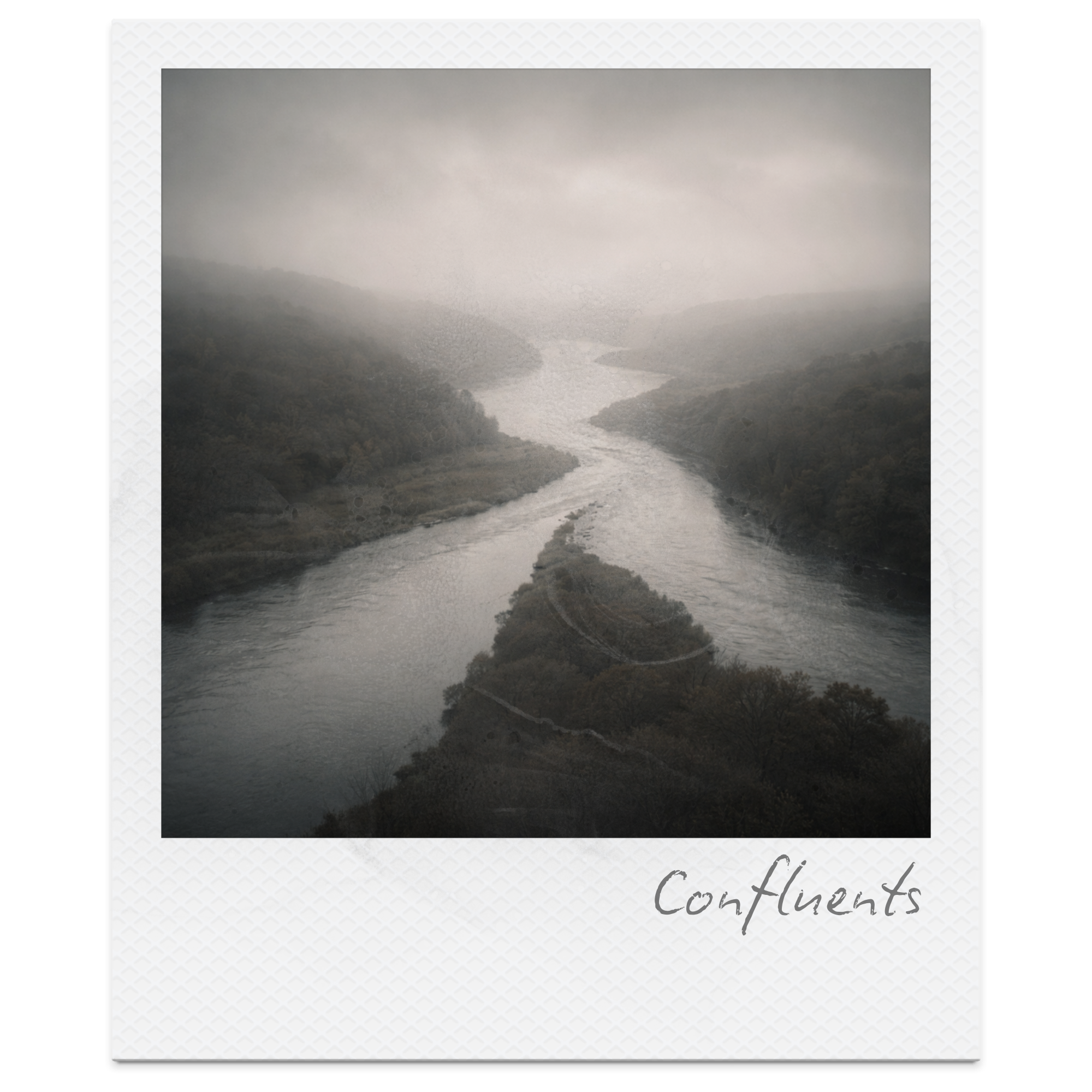 A winding river flowing through a valley with forested hills on either side, viewed from an elevated position on a cloudy day.