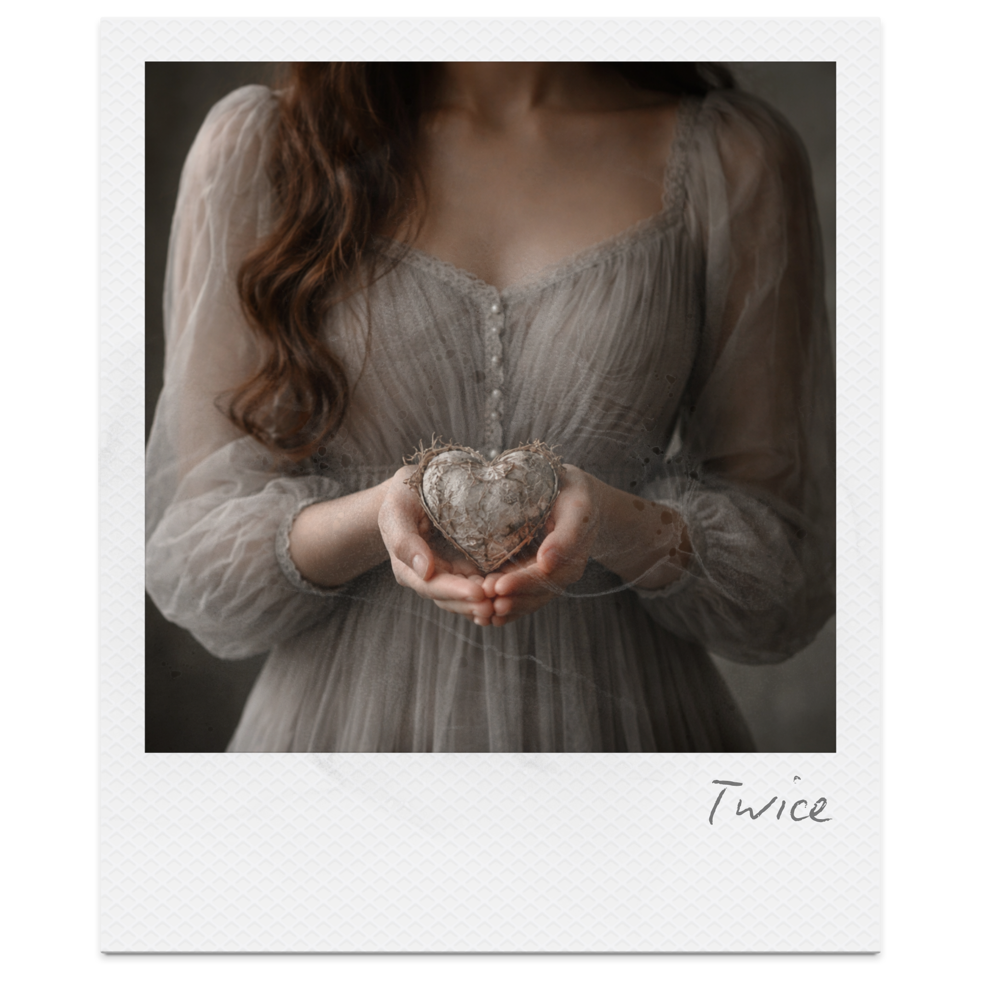 A woman in a vintage-style, grayish dress with lace details holds a heart-shaped object made of dried, weathered material. The image has a soft, moody tone with a blurred dark background. The word "Twice" is written in cursive at the bottom right cor