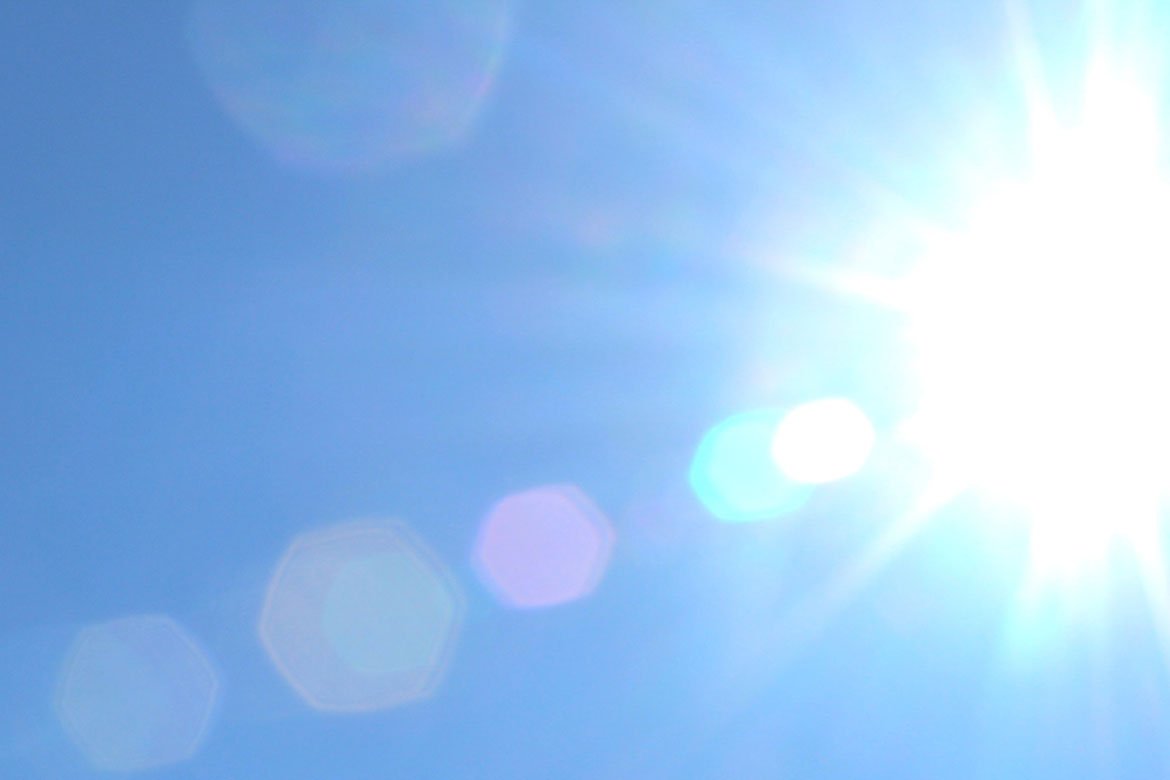Blaring Sun in clear blue sky