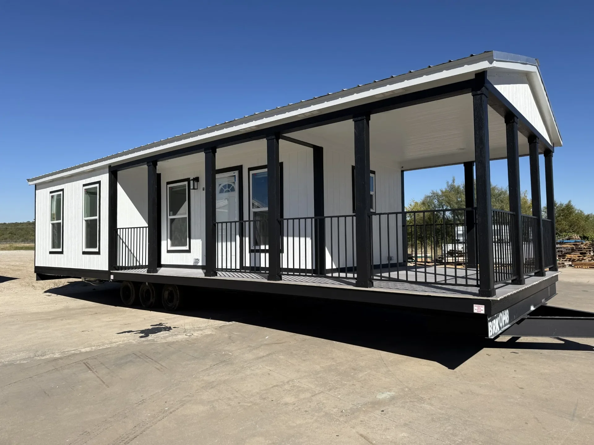 Tiny manufactured home exterior with modern siding at Homestead San Antonio