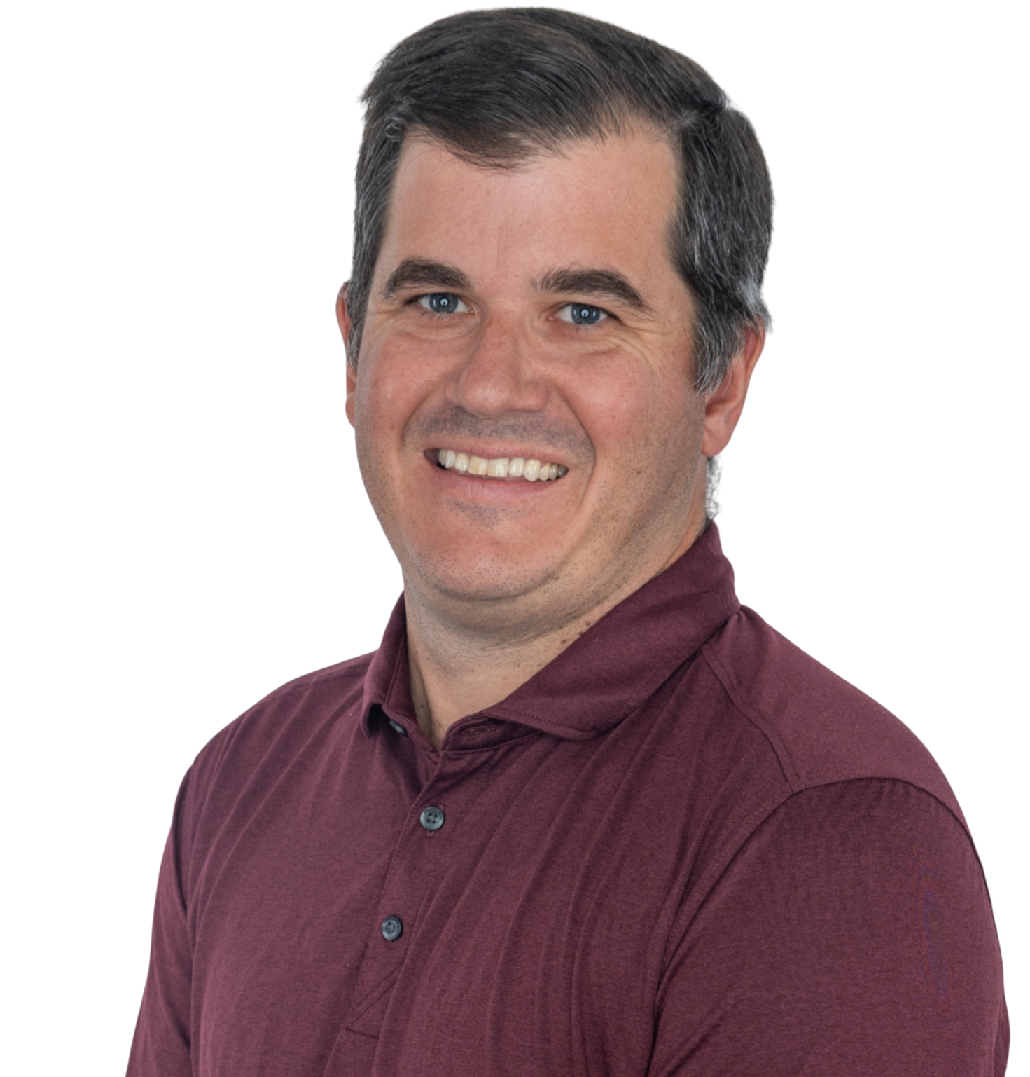 Headshot of a smiling man with dark hair and blue eyes, wearing a maroon button-up shirt.