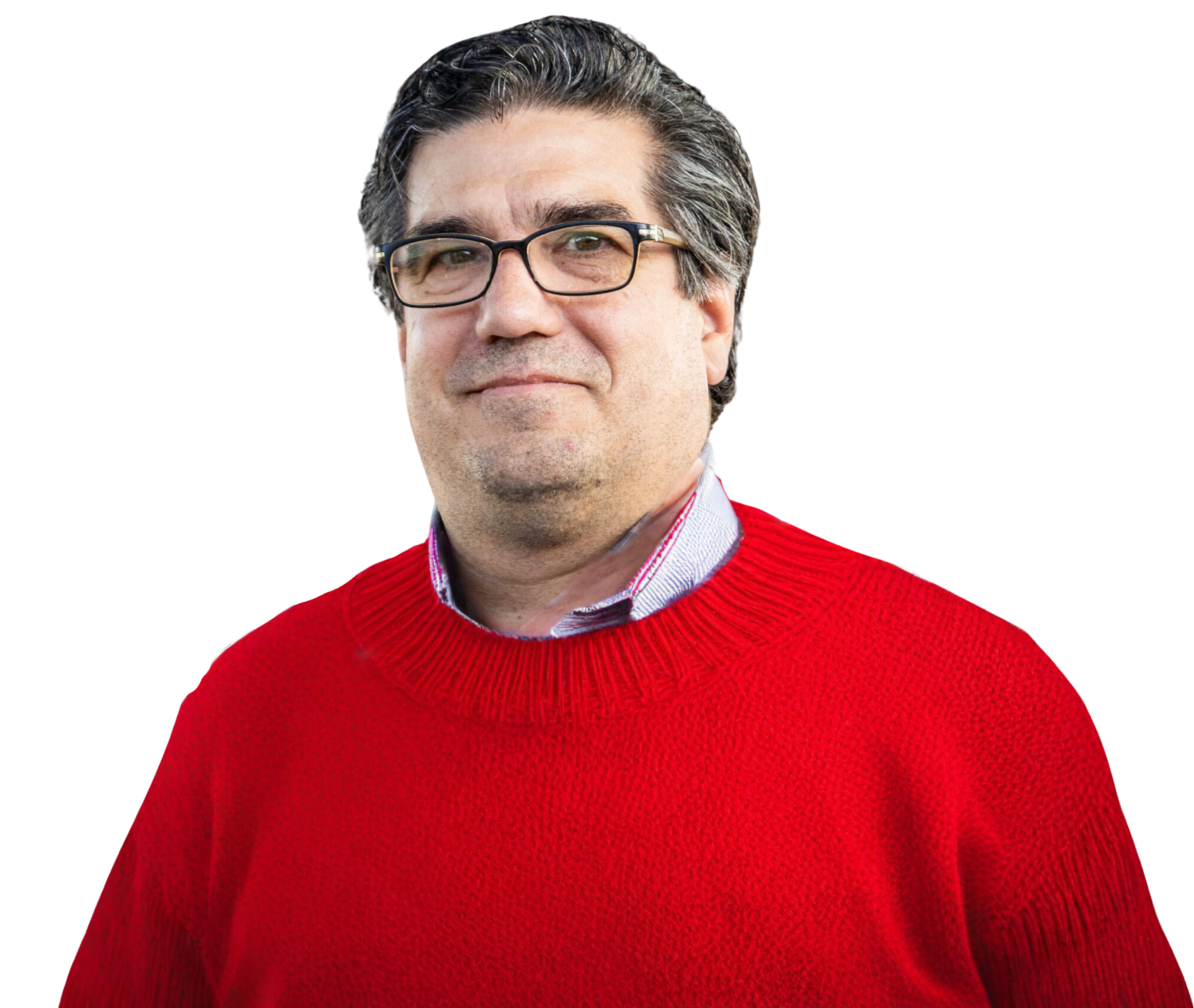 A middle-aged man with dark hair and glasses, wearing a red sweater and a collared shirt, smiling softly