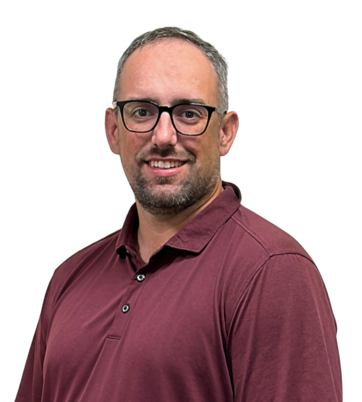 A man with glasses and a beard wearing a maroon polo shirt, smiling at the camera.
