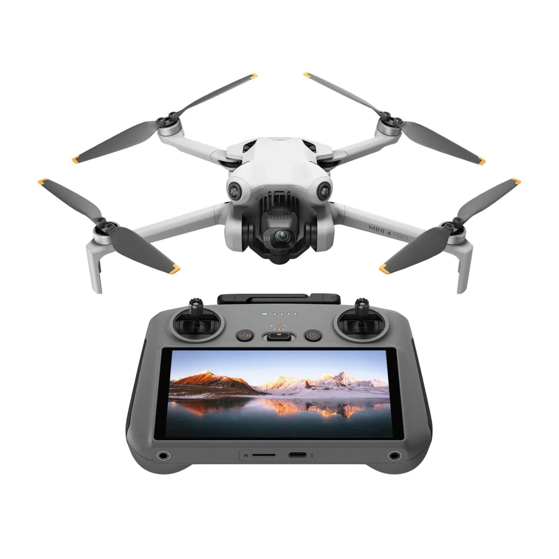 Overview of a drone with four propellers and its remote control with a screen showing a landscape of mountains and water.