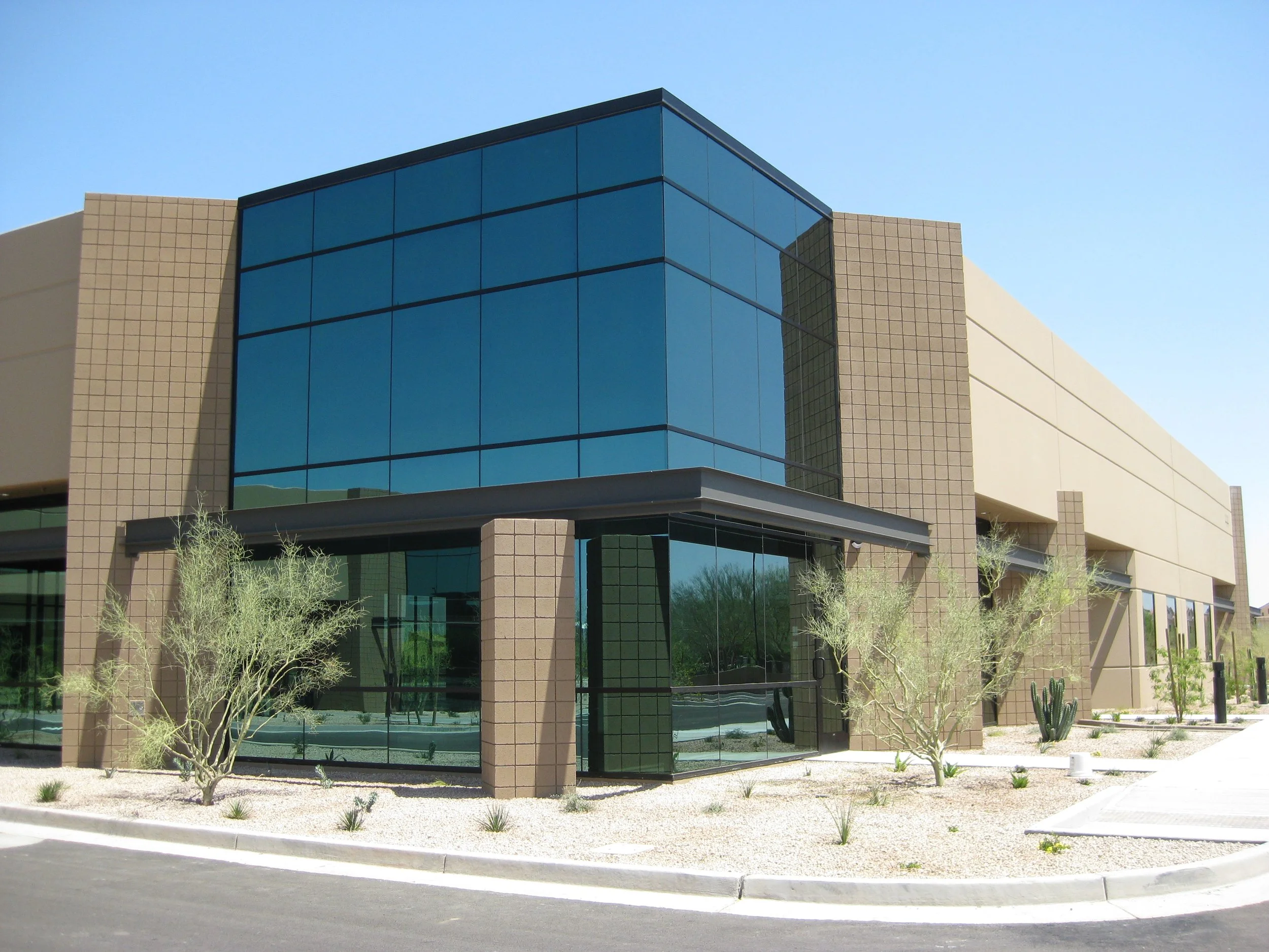 Modern flex office / industrial building with glass façade and landscaping at FRIP.