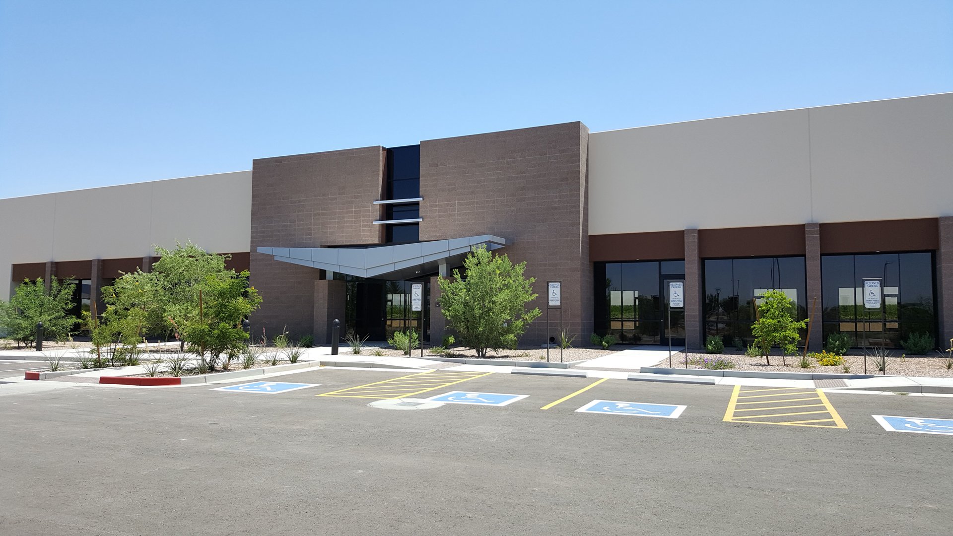 Modern commercial flex office / industrial building with large windows, and entrance canopy at Tiburon.