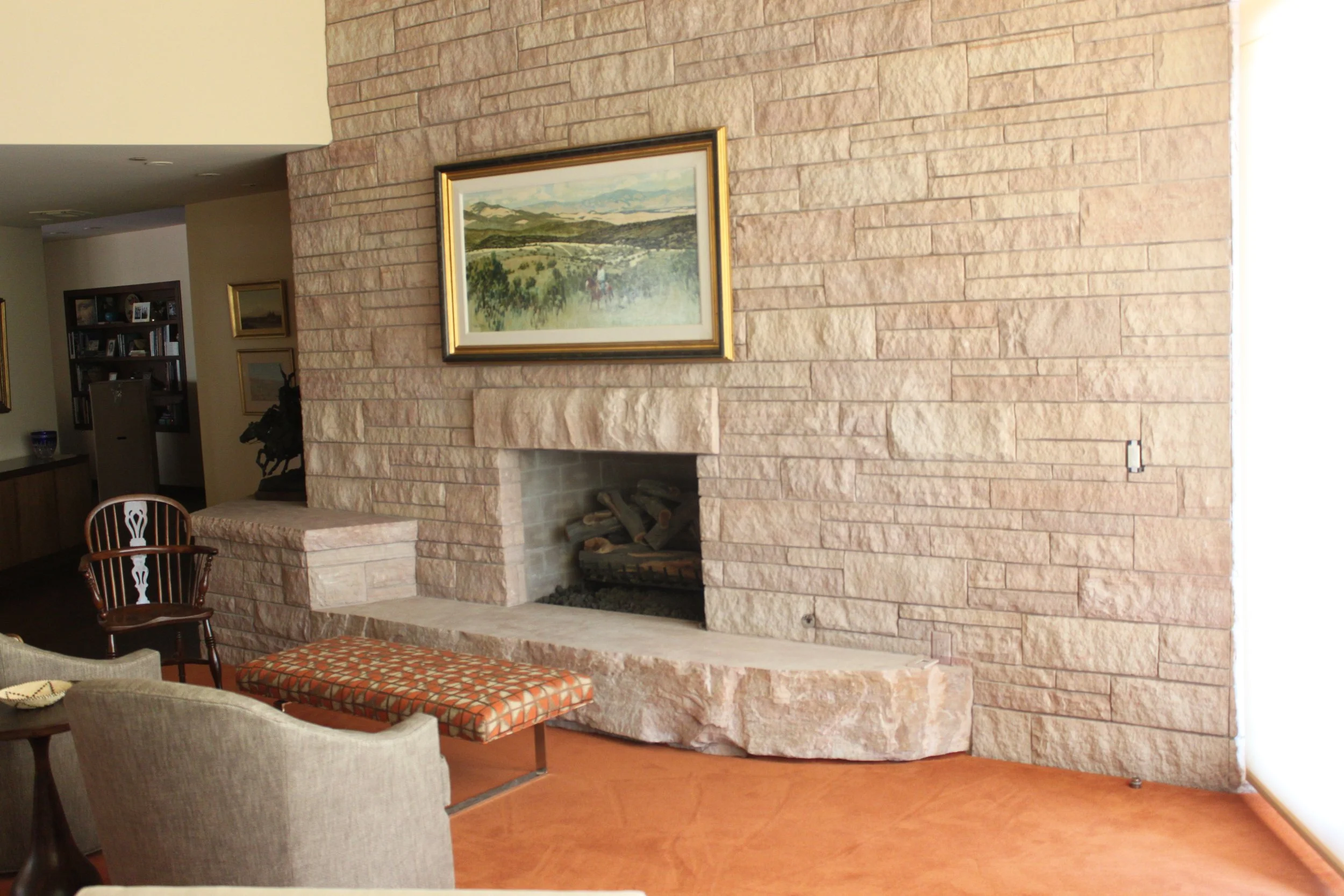 Living room with stone fireplace.