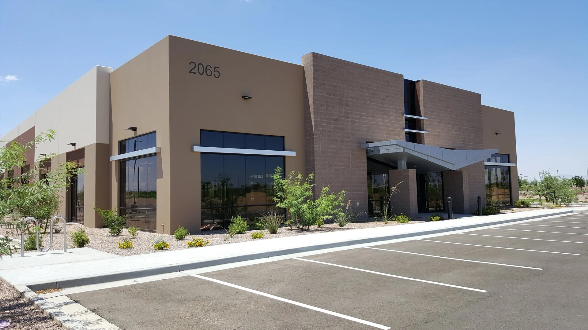 Modern commercial flex office / industrial building with large windows, and entrance canopy at Tiburon.