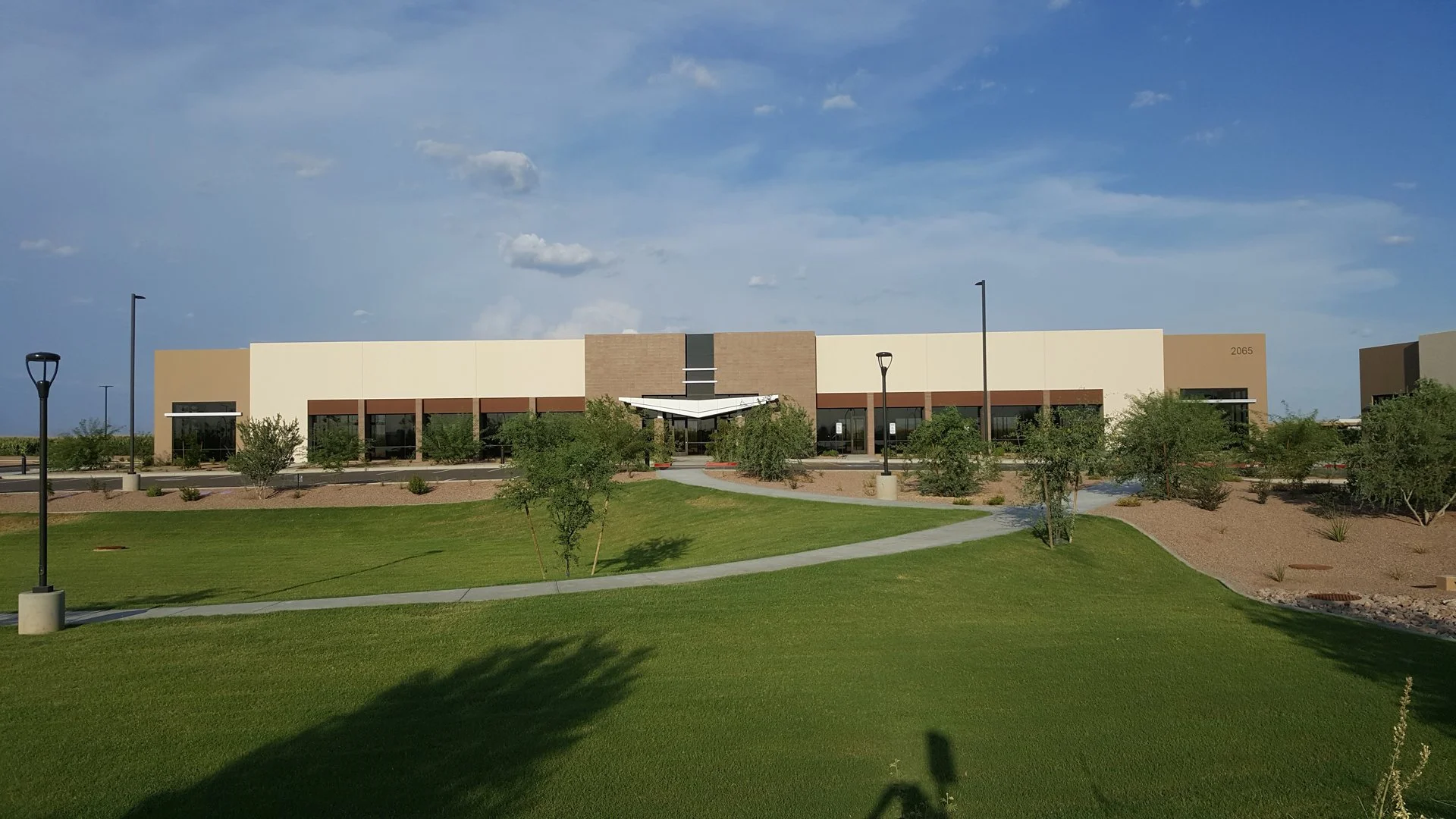 Modern office / industrial building with large windows, with common park at Tiburon.