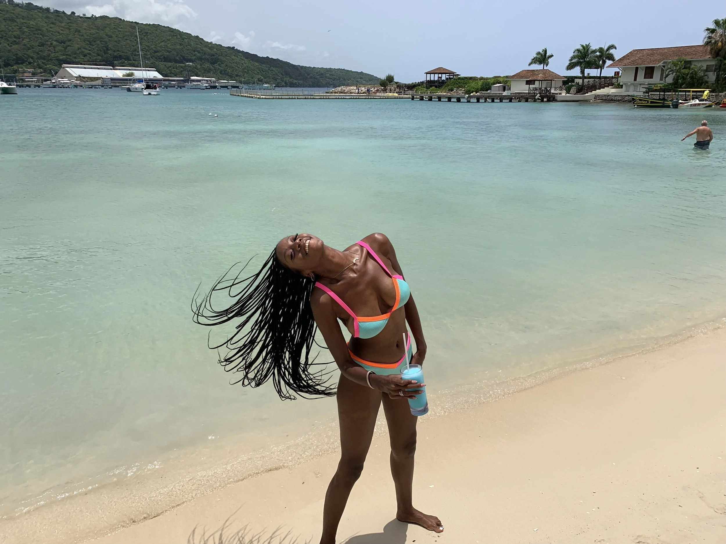 tossing hair braids on the beach