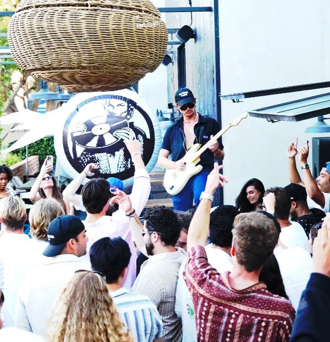 Photo of DJ duo Side One performing on outdoor patio at zinqué Malibu, a fFrench restaurant