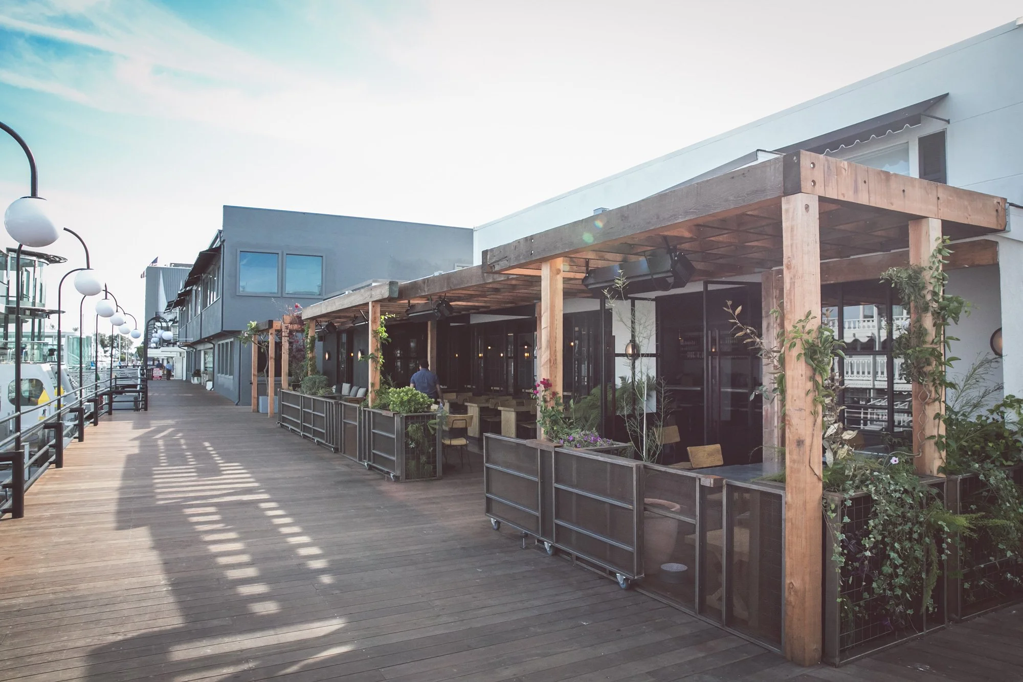 Photo of outdoor patio on boardwalk at zinqué, a French restaurant in Newport Beach