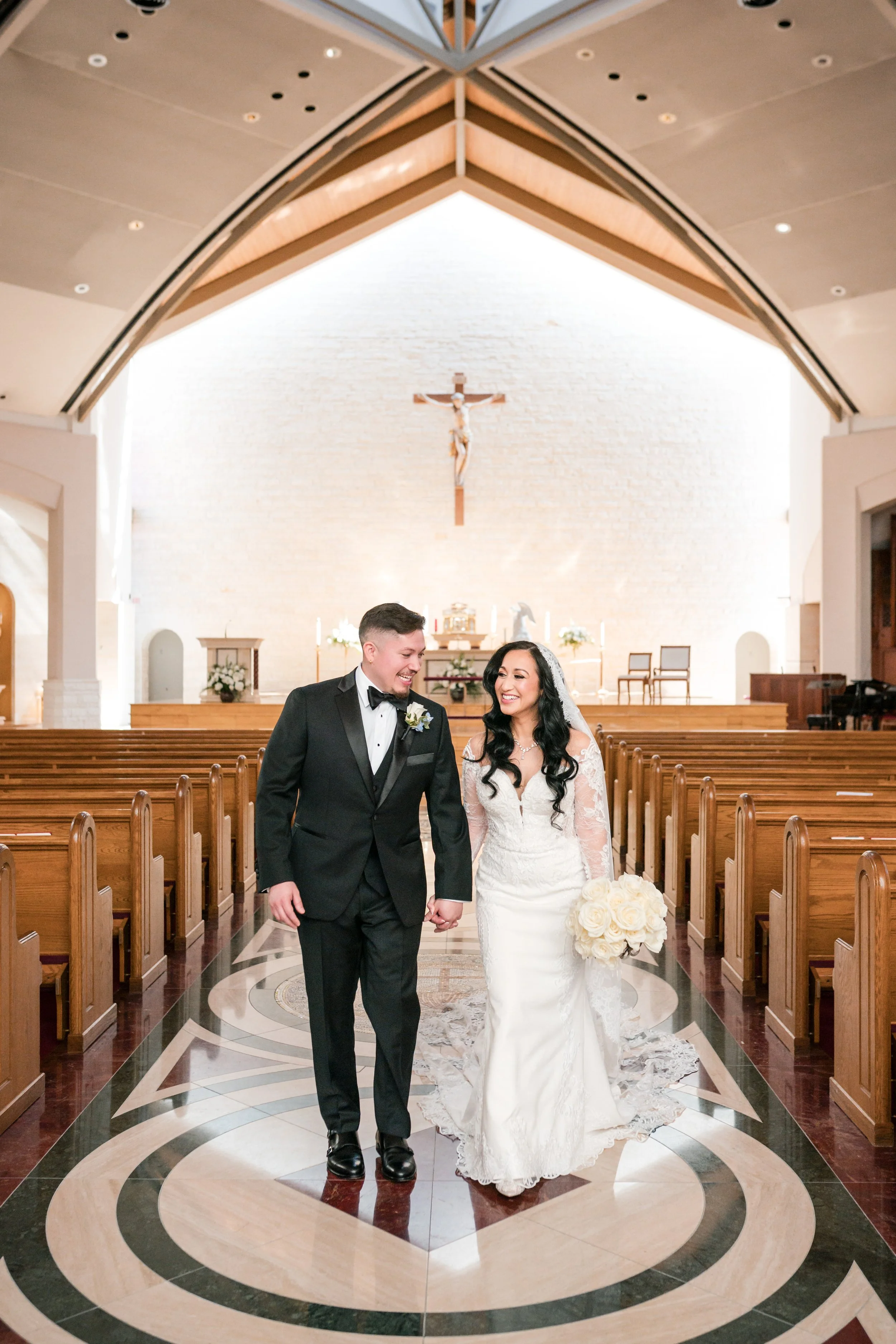 a couple is walking down the alter in a catholic church 
