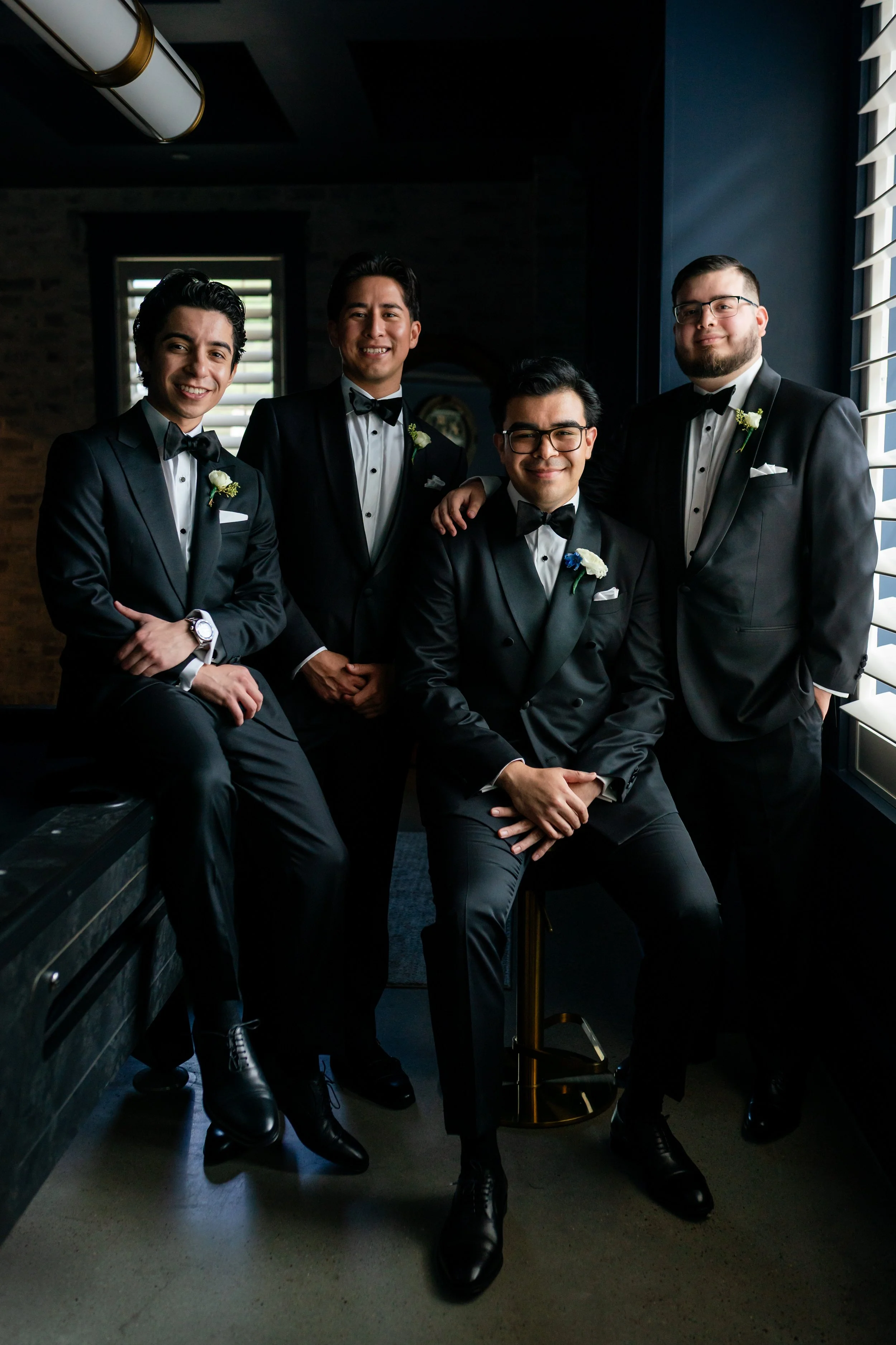 a groom and his groomsmen taking a posed photo 