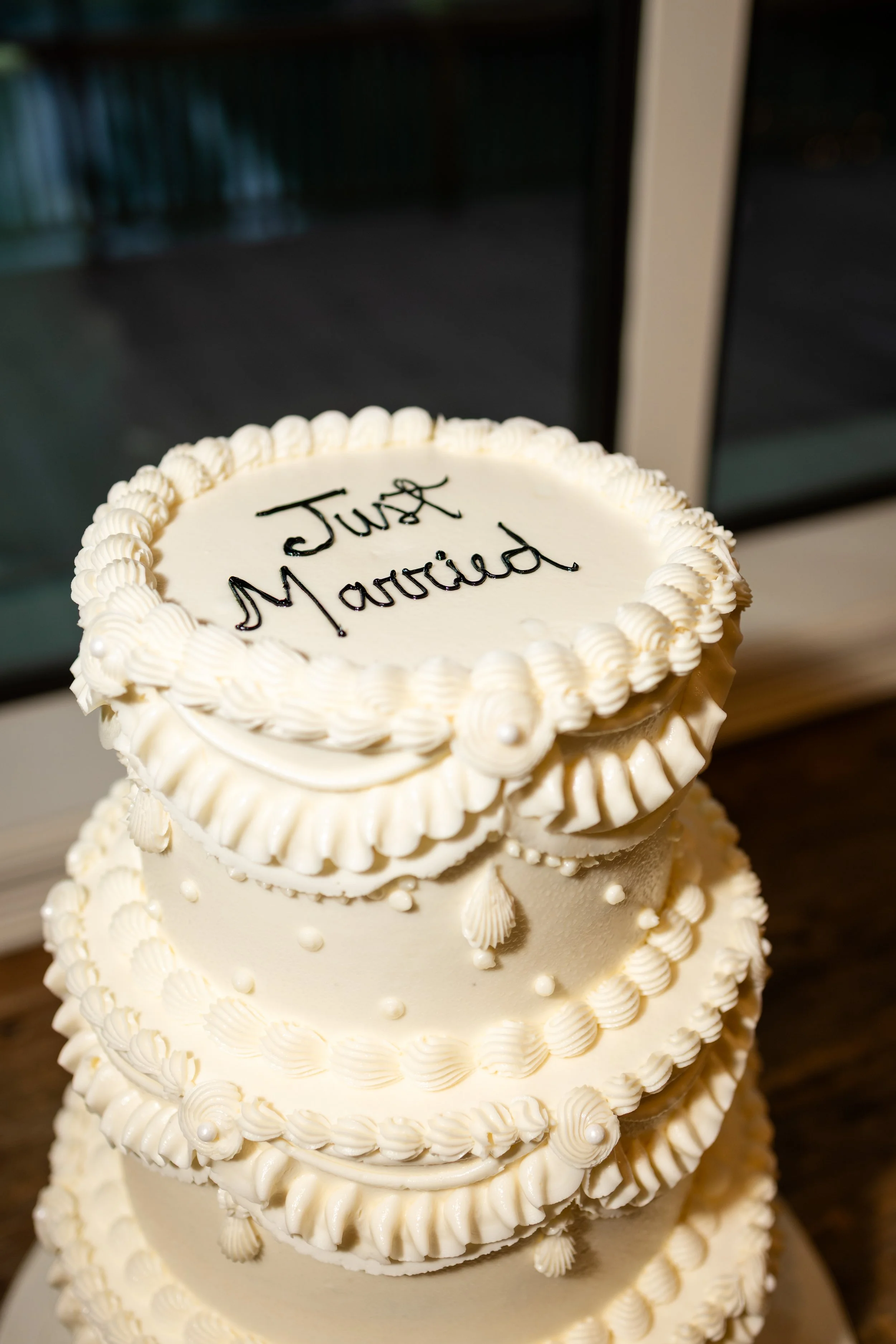 a cake that says just married and has multiple layers