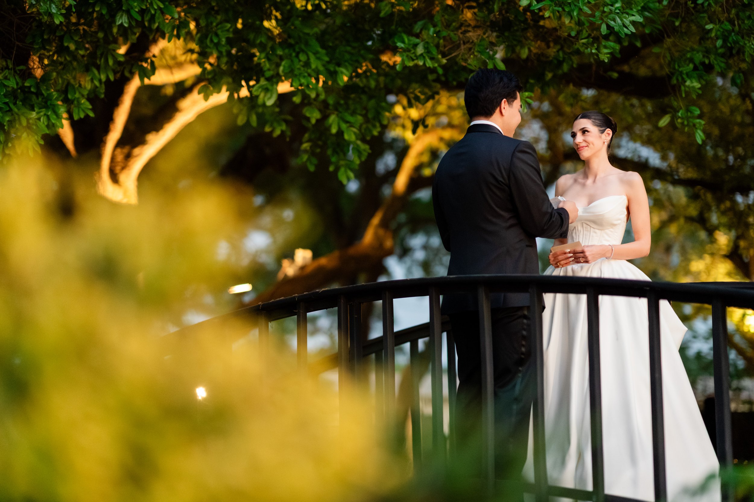 a bride and groom at the peach orchard in houston looking at each other fondly 
