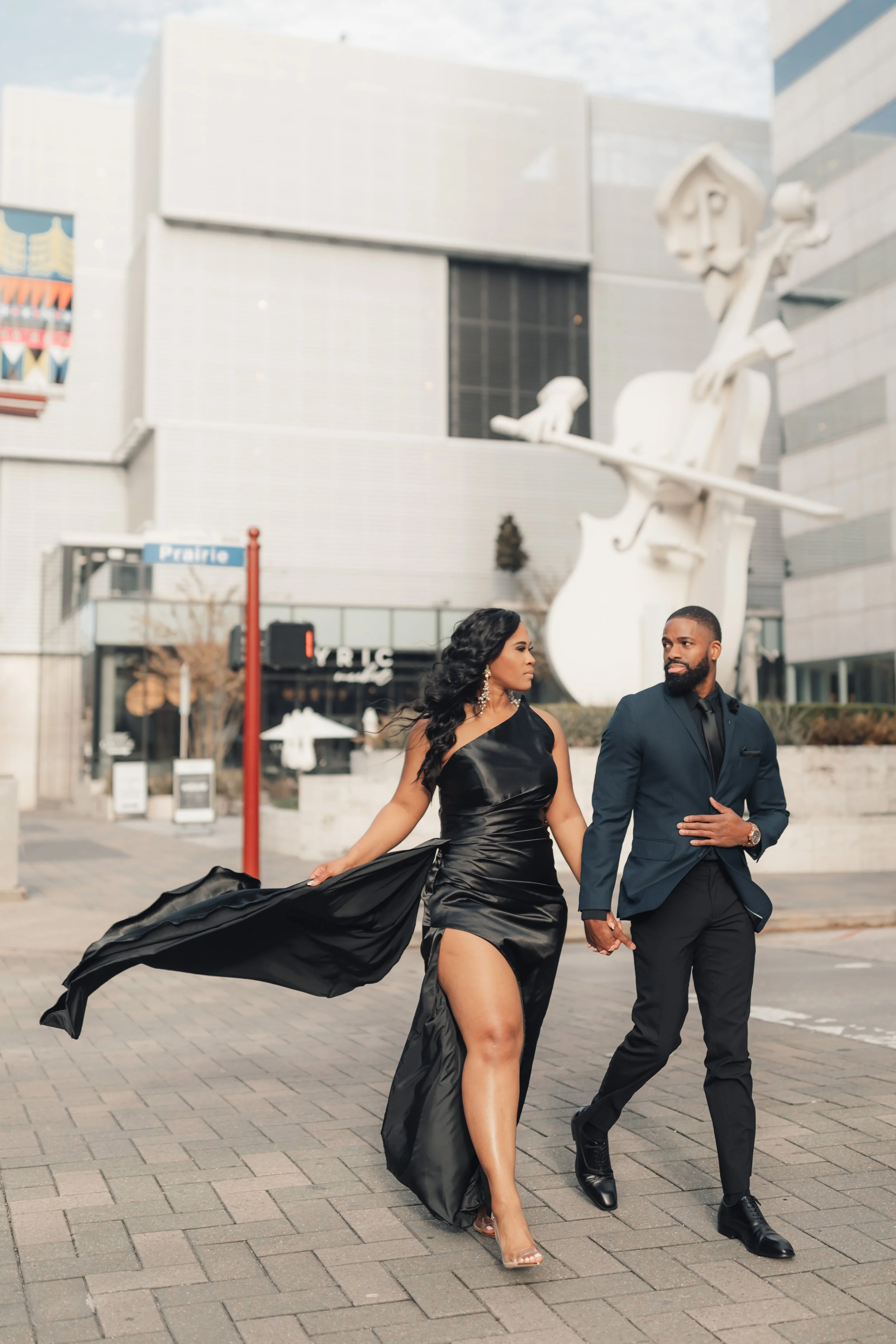 a couple taking their engagement session pictures in the street walking off 