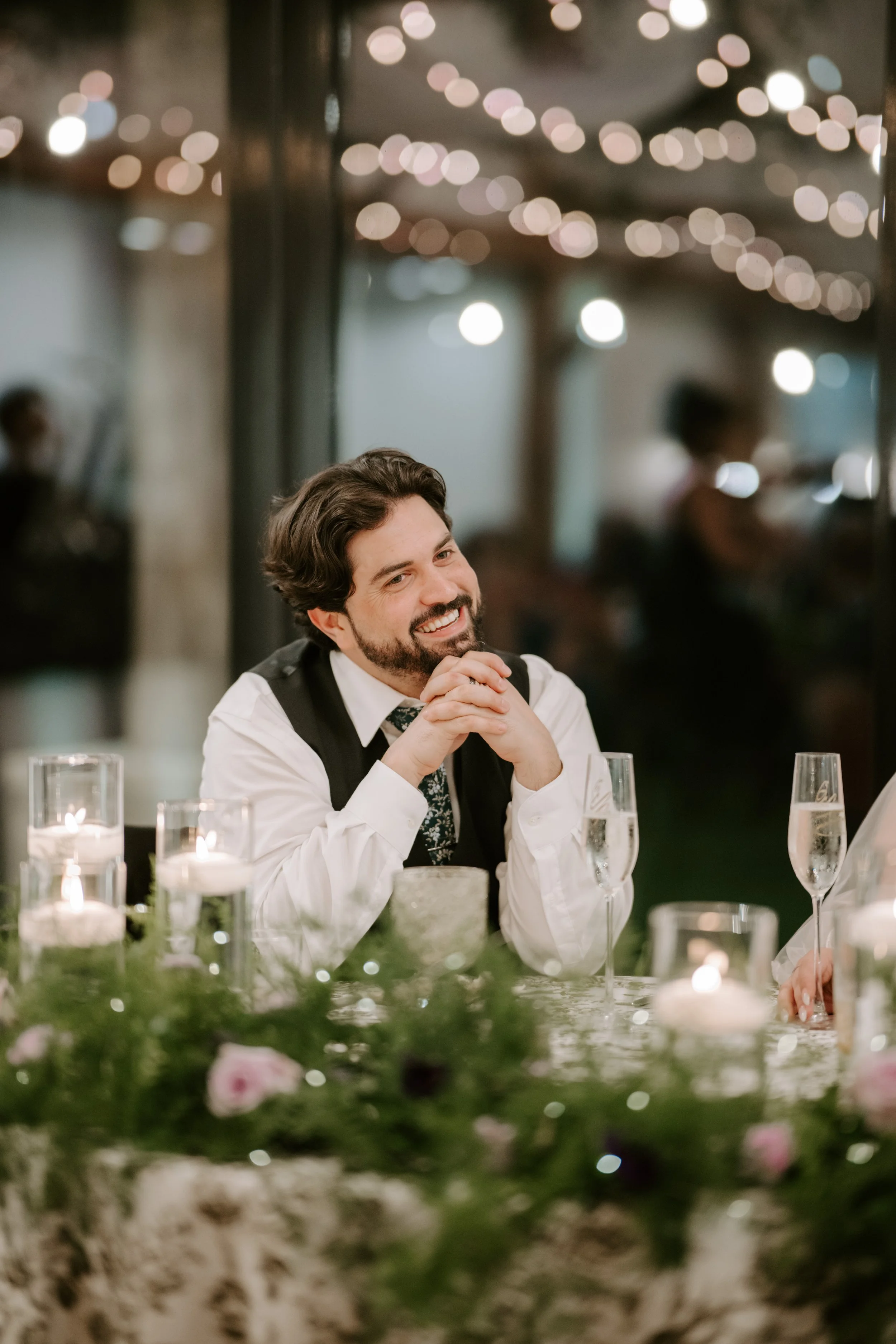 a groom is looking fondly at someone speaking 