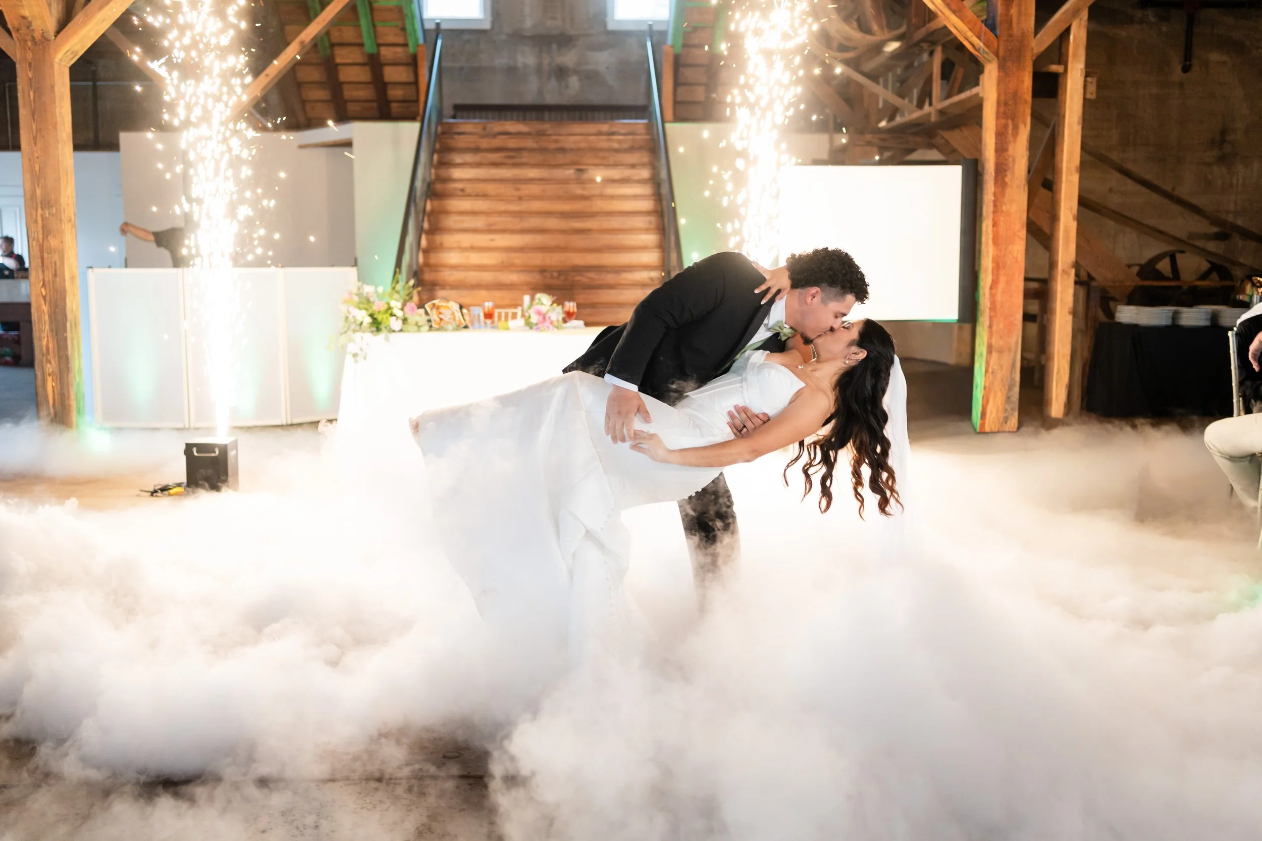 a couple is celebrating their wedding with a kiss on the dancefloor