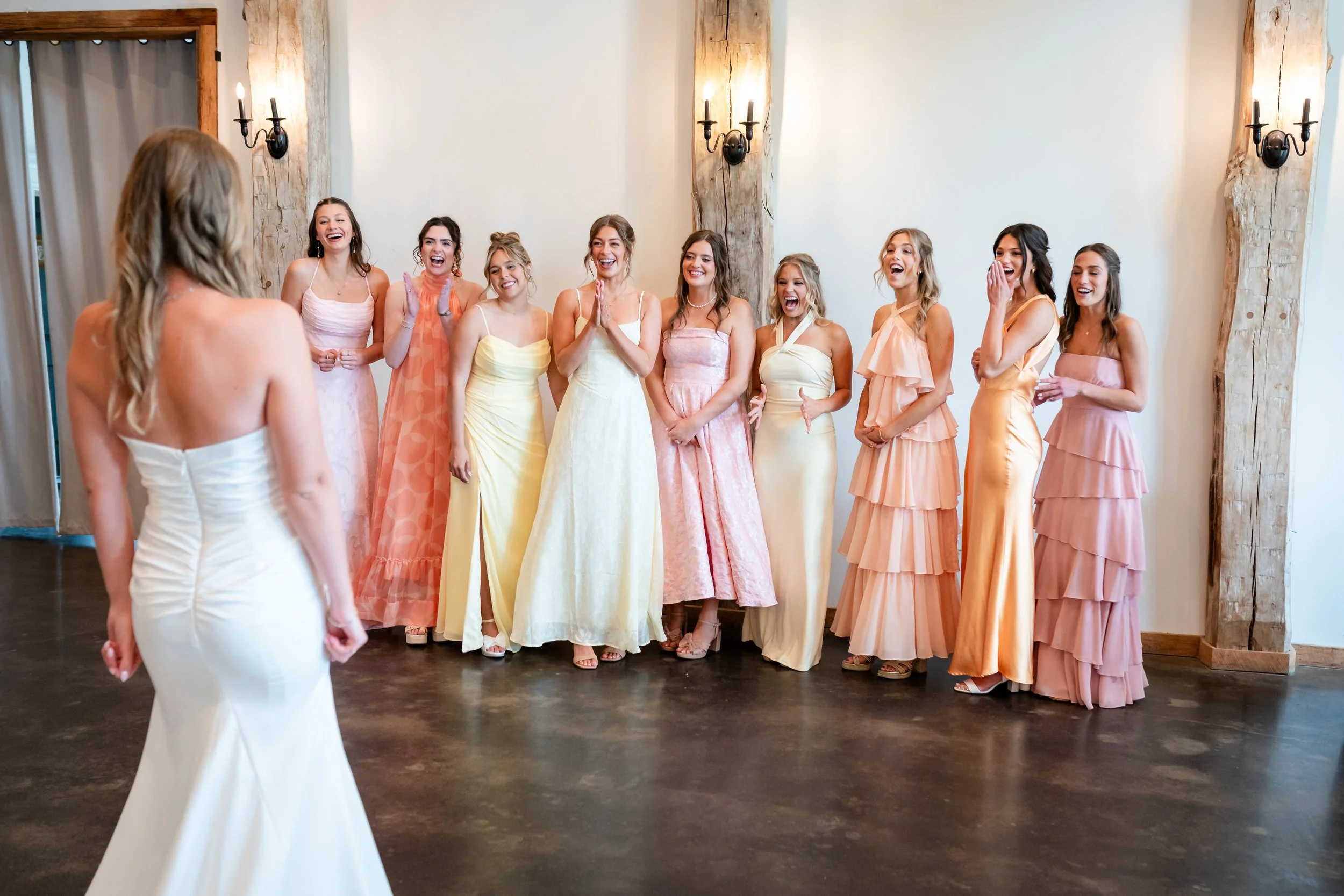 a bride doing a dress reveal for her bridesmaids 