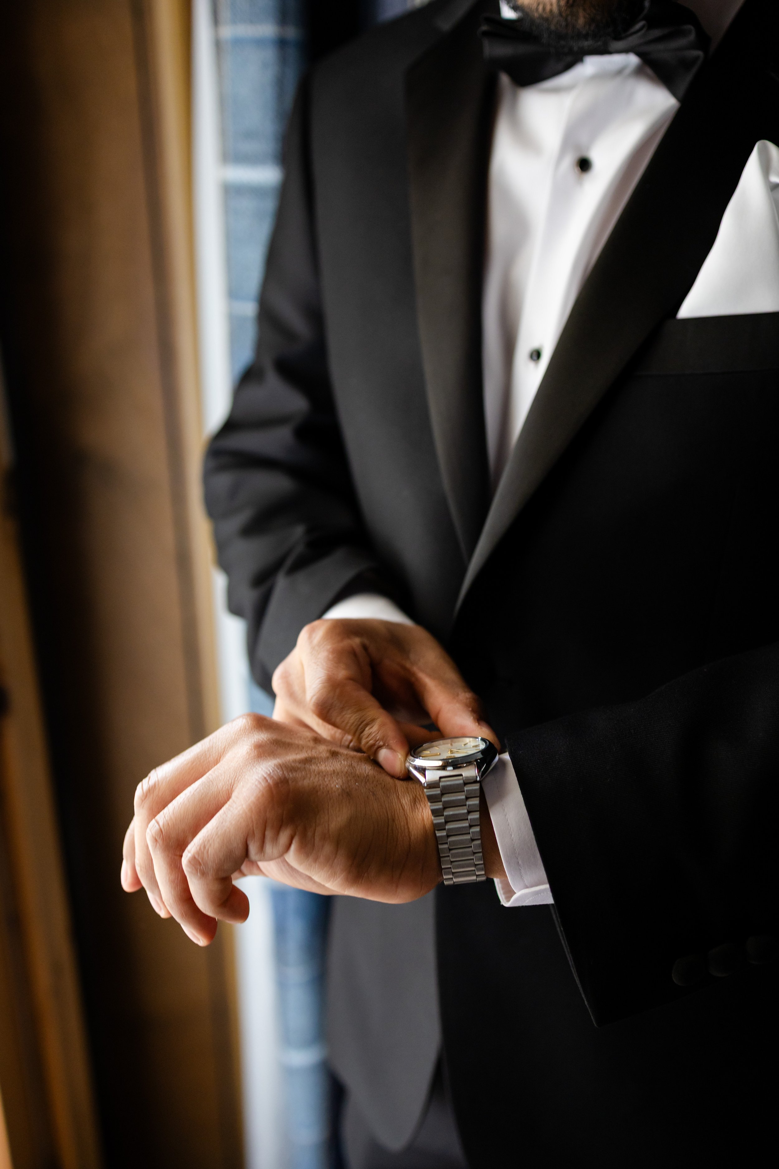 a man is looking at his watch and checking the time 