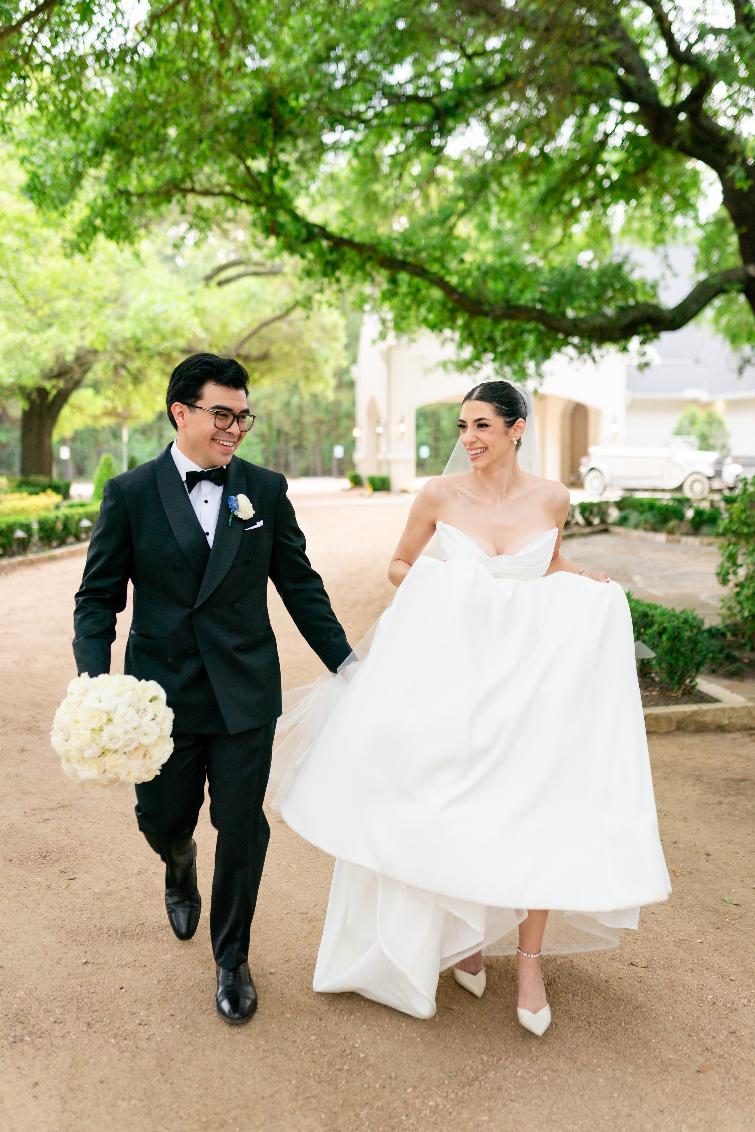 wedding in houston of bride and groom running down a path to the venue space