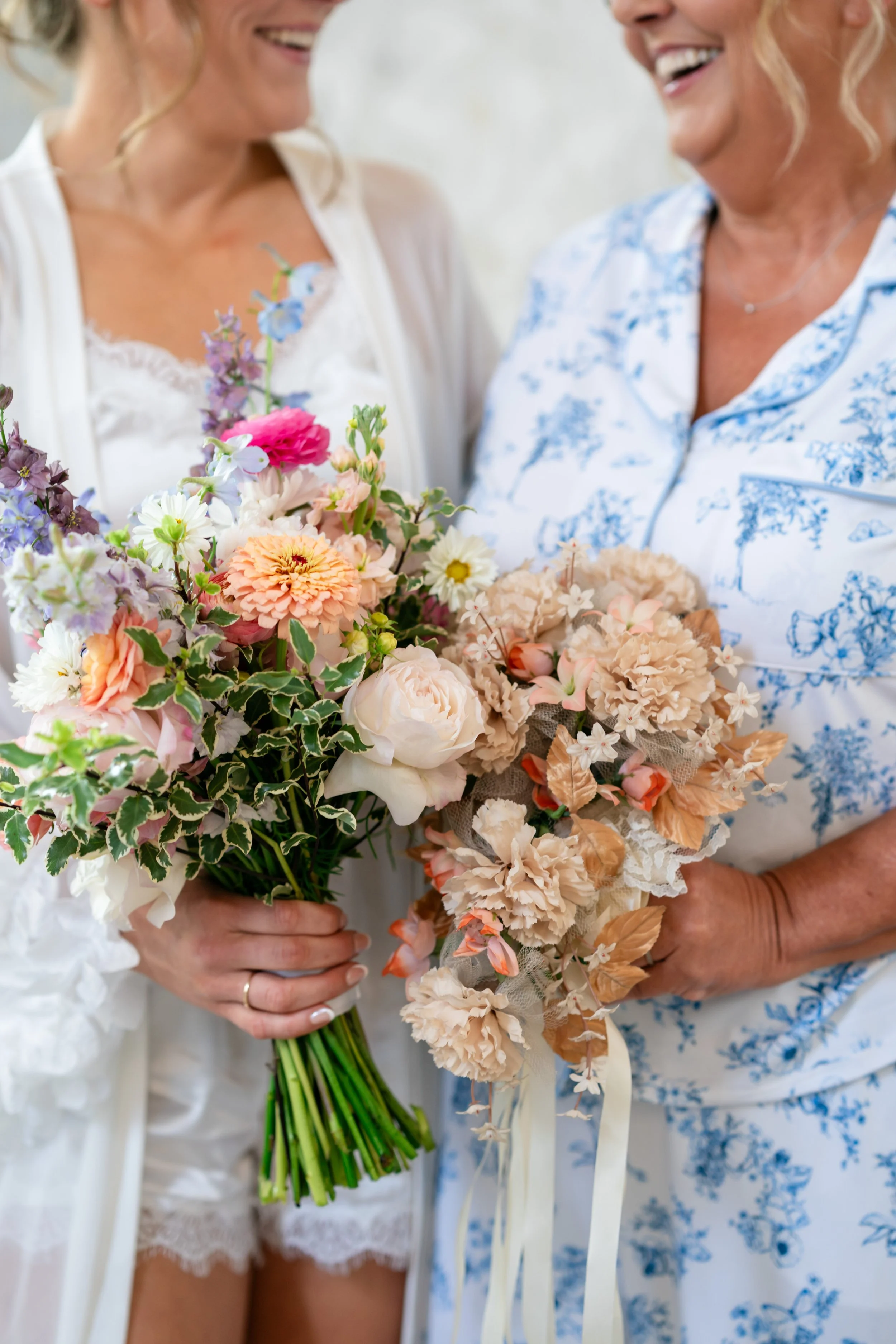 a bride and her mom holding flowers of something old and something new