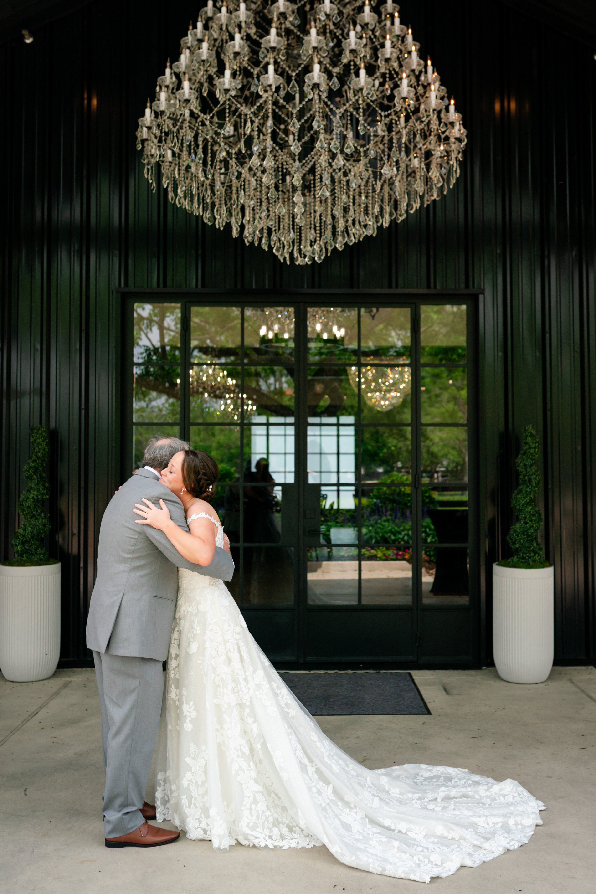 a woman is hugging her dad while doing a first look