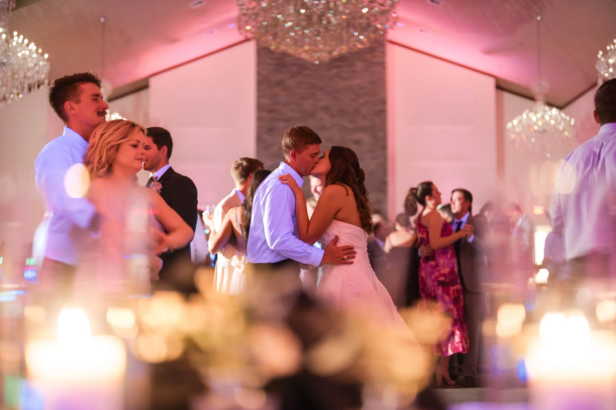 a couple is kissing on the dancefloor