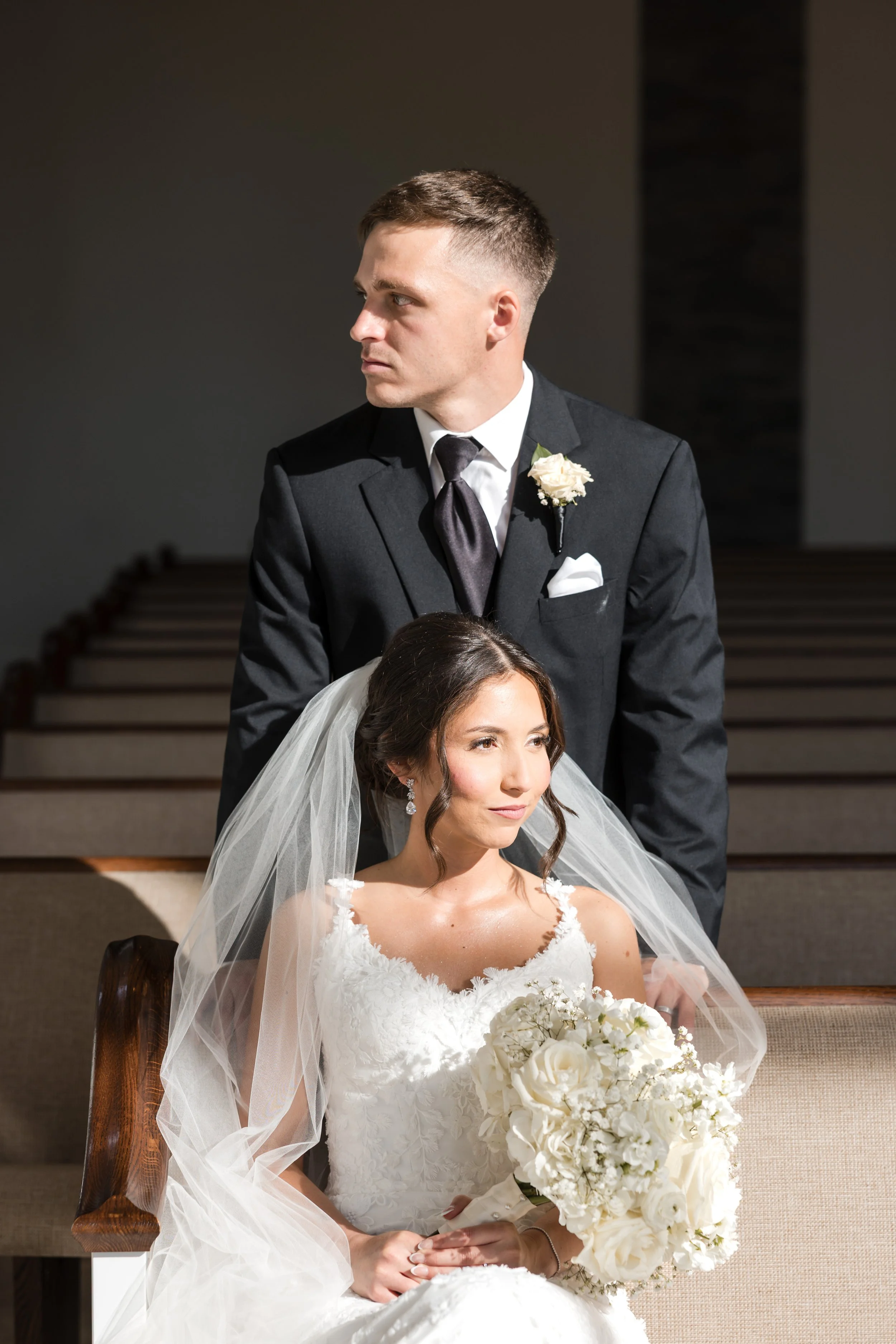 a bride and groom at the church while looking in different directions