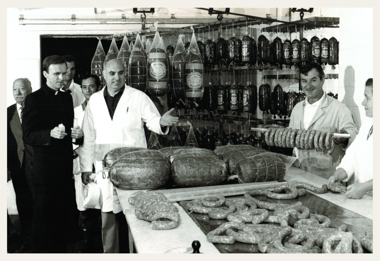 Bruno inspecting the meats with workers.