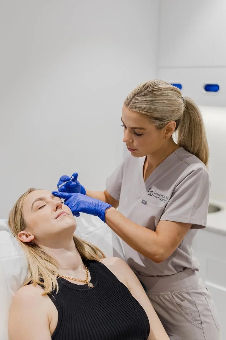 A woman receives a cosmetic treatment from a professional dermatologist in a clinic.