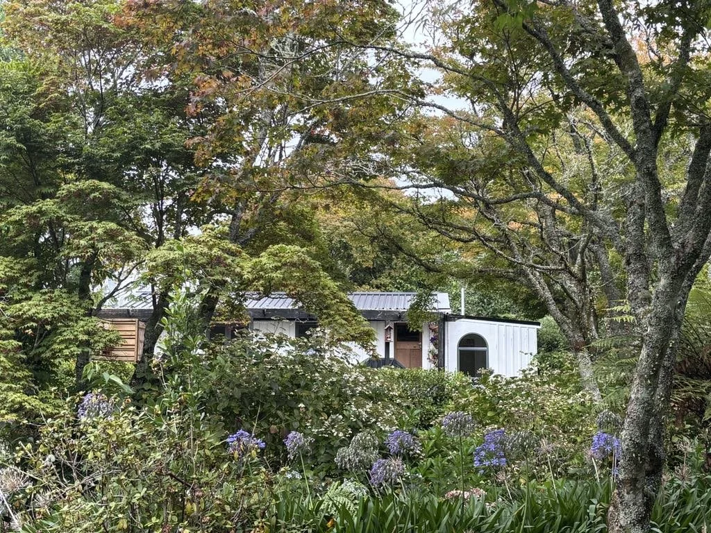 Pheasant Hill Cottage set amongst the trees and overlooking the pond and wildlife.