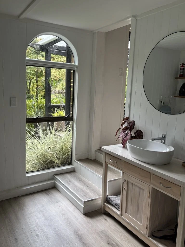 Step down into Pheasant Hill Cottage's bathroom and laundry.