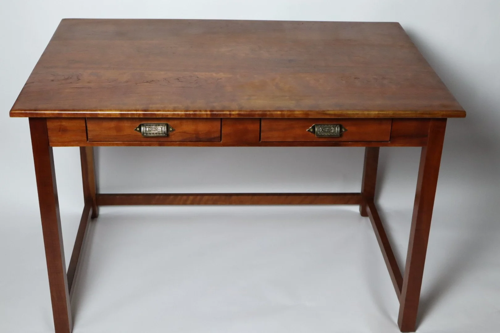 This Cherry Desk has been used every day for the past 15 years. All are handcrafted using traditional joinery methods. Desks like this can be made to any dimension that would fit your space. This desk has two drawers; it can be built with one or none